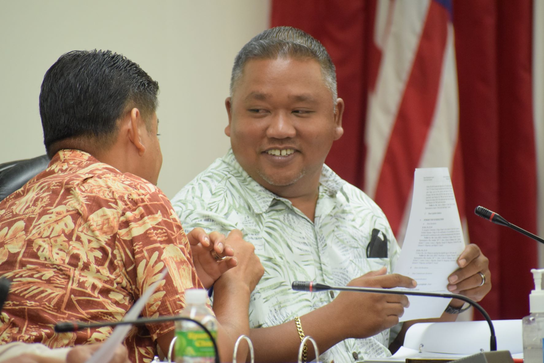 Rep. Roy Ada, left, back to the camera, converses with House Minority Leader Angel A. Demapan during a break from a House session on Wednesday.