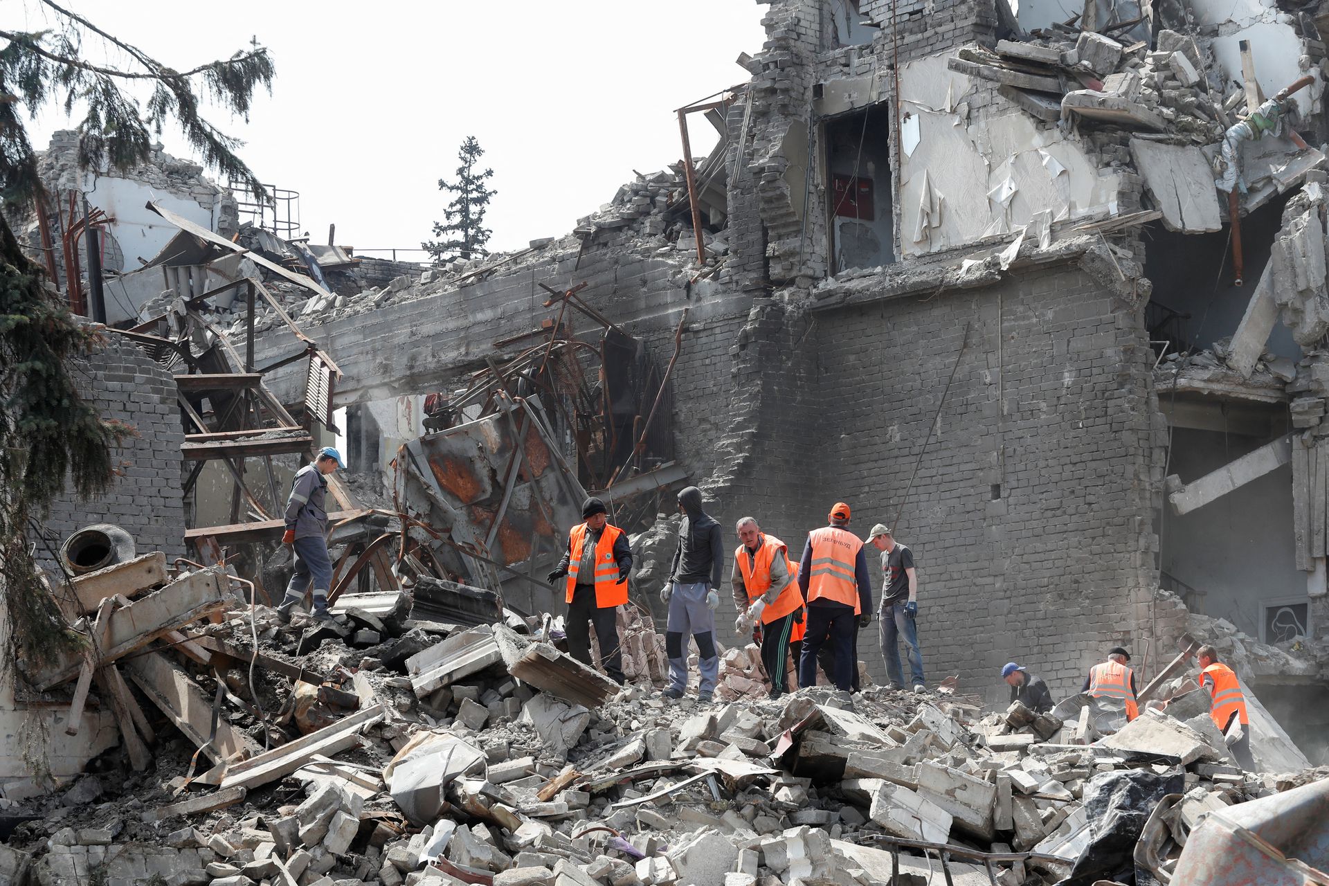 Emergency management specialists and volunteers remove the debris of a theater building destroyed in the course of the Ukraine-Russia conflict in the southern port city of Mariupol, Ukraine, April 25, 2022.
