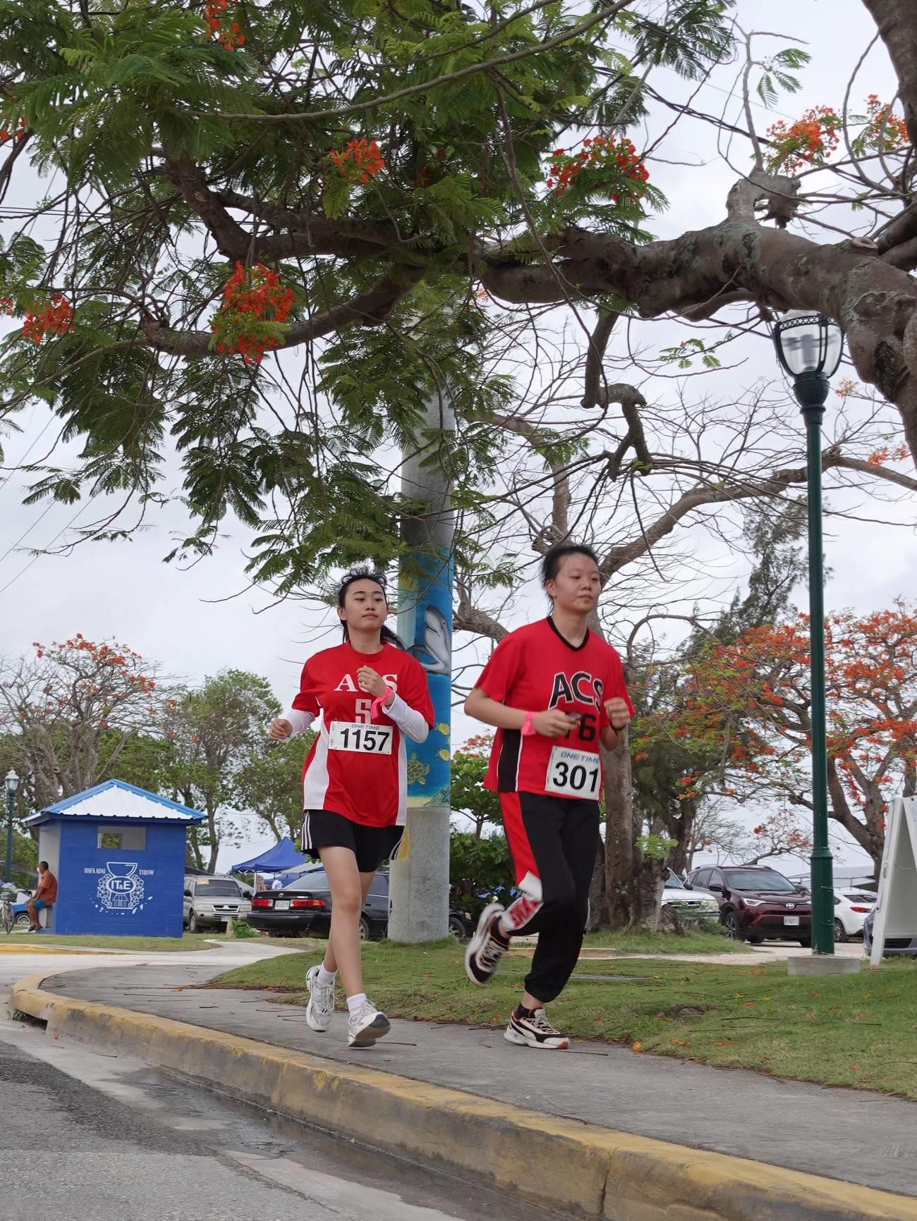 Yidan Zheng, left, and Esther Jingui Zhou tackle the 5K course in the Saipan Marathon on April 9, 2022.