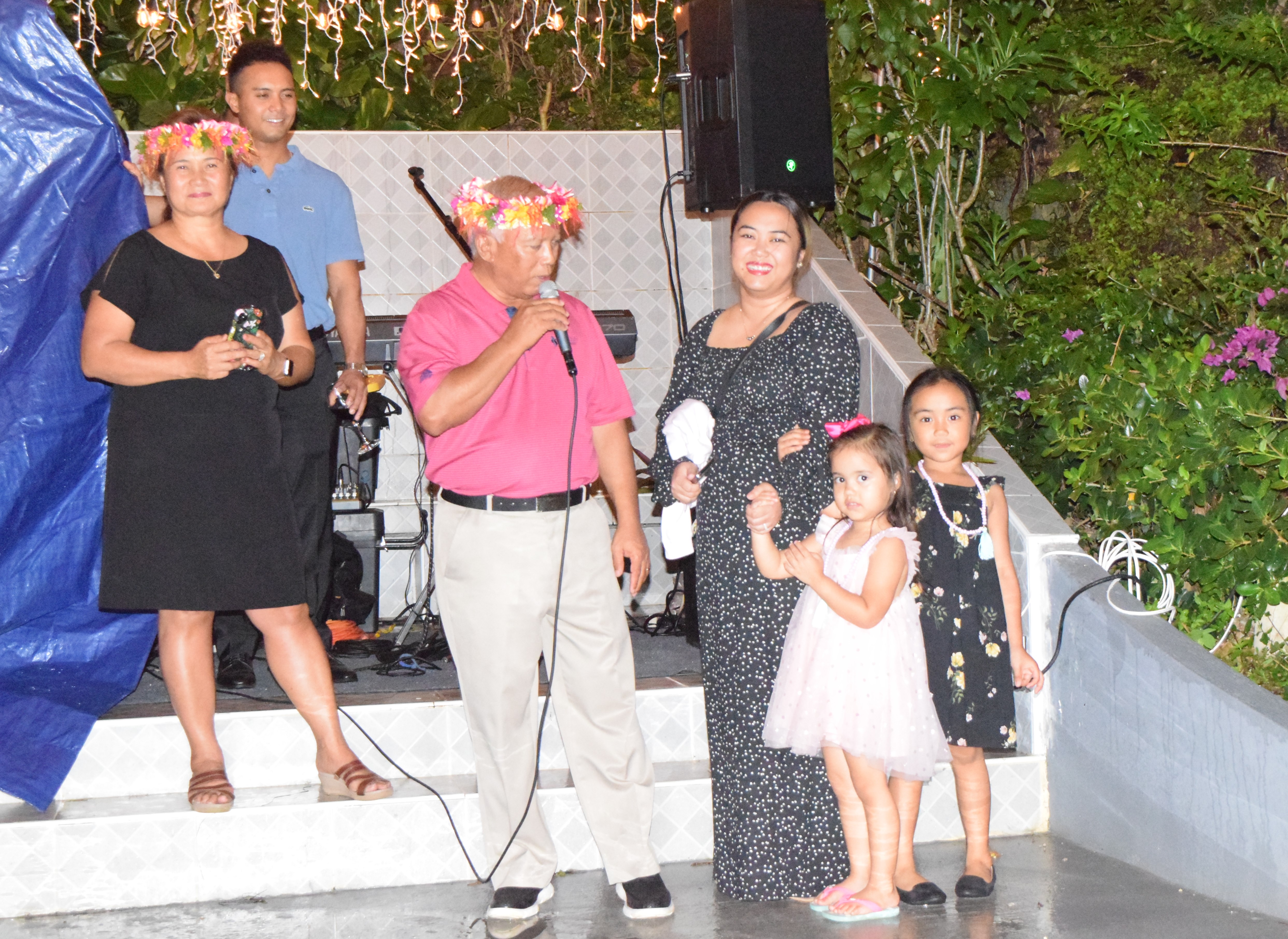 McDonald's Saipan-Guam President Jose Ayuyu Sr. center, introduces his granddaughters, Hanalei Moana and Katana, as his wife, Marcia, left, son, Joe Ayuyu Jr., second left, and daughter Natalie Mable Ayuyu-Glenn smile during Ayuyu Sr.’s 70th birthday celebration at their residence in Papago on Friday.1