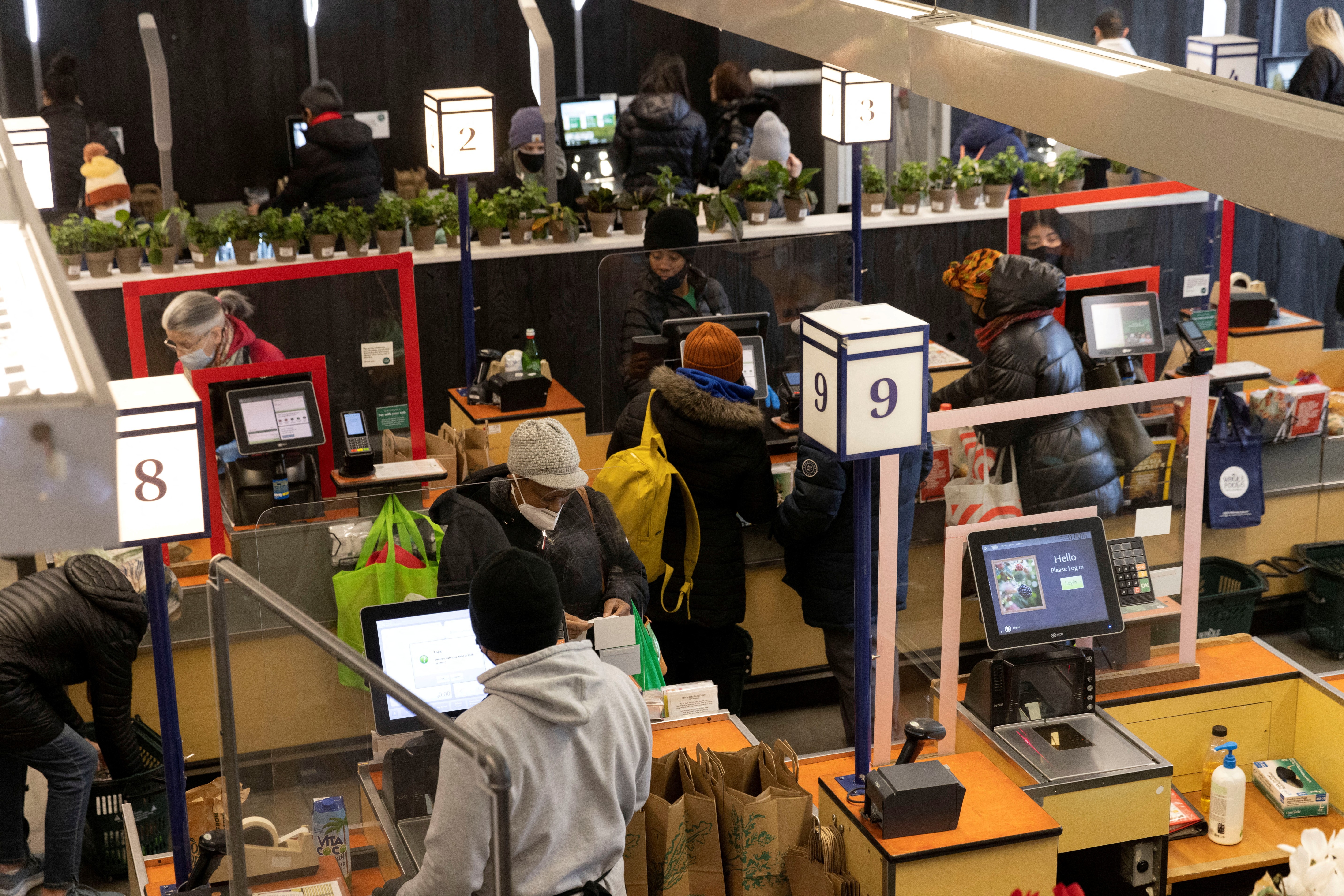 People pay for their purchases at a supermarket in Manhattan, New York City on March 28, 2022.