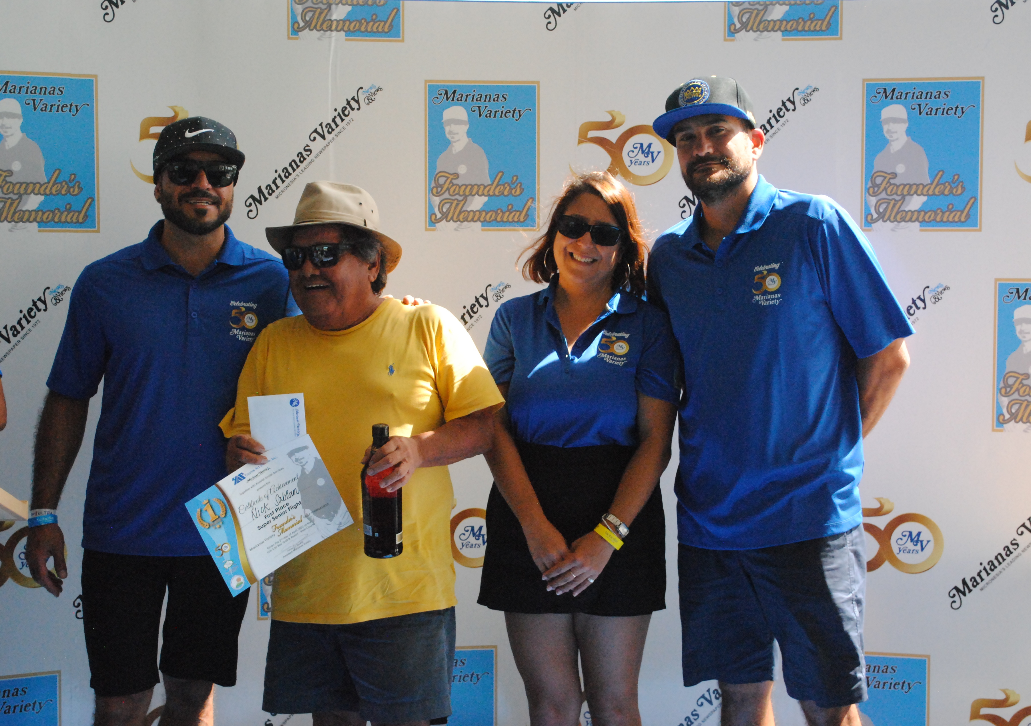 Nick Sablan 2nd left, poses with Marianas Variety President Amier Younis, left, and siblings Farah Younis, 2nd right, and Salam Younis during the awards ceremony of the MV Founder's Memorial Golf Tournament at Laolao Bay Golf & Resort on Saturday. 