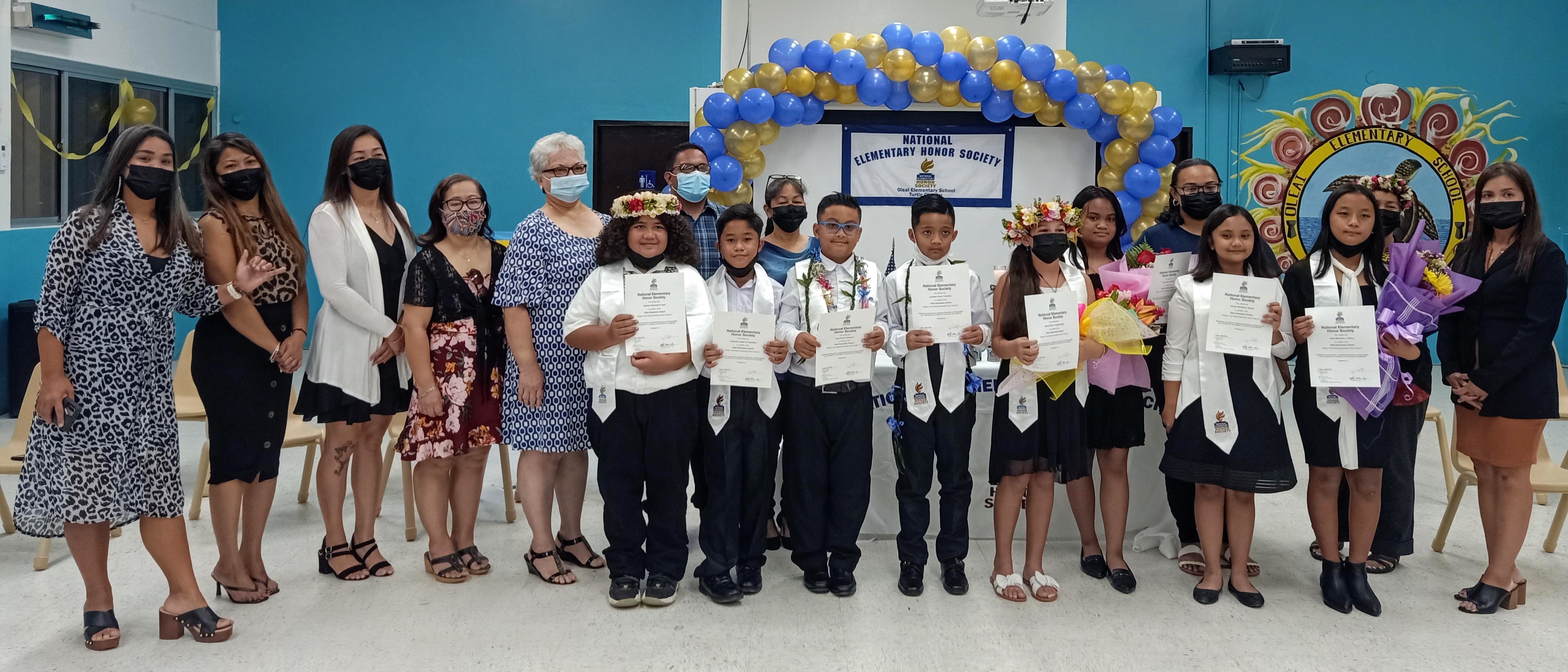 Oleai Elementary School National Elementary Honor Society members pose for a photo with school administrators and faculty members following the induction ceremony in the OES cafeteria on April 8, 2022.