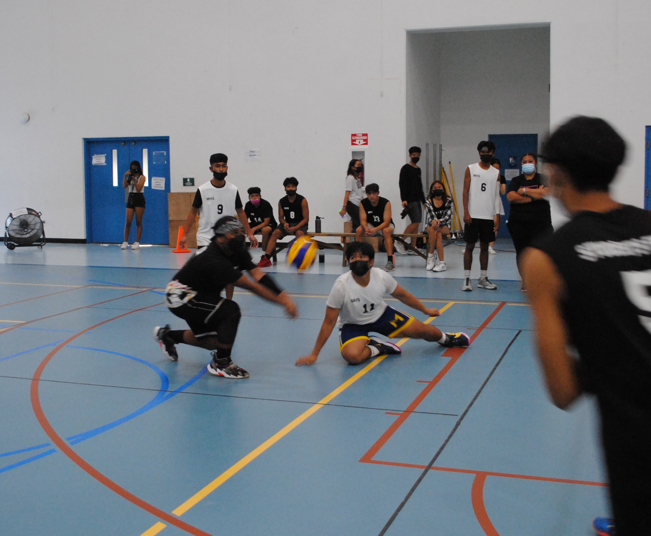 MHS 2 players reach out to save the possession during a PSS Boys High School Volleyball game Saturday at the MHS gym.