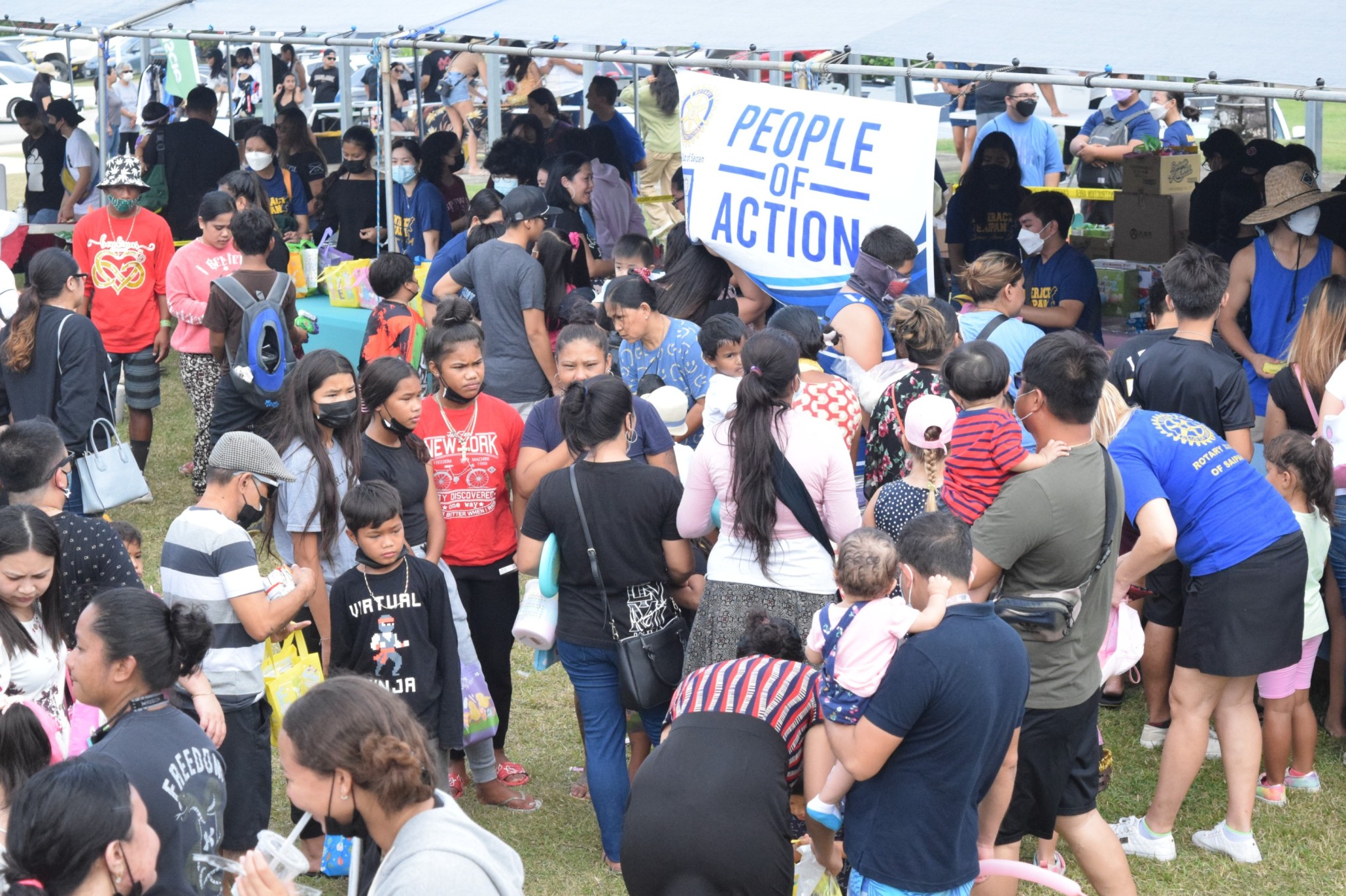 Children and their parents visit the booths at the NMI Museum grounds after the Easter egg hunt at Sugar King Park.