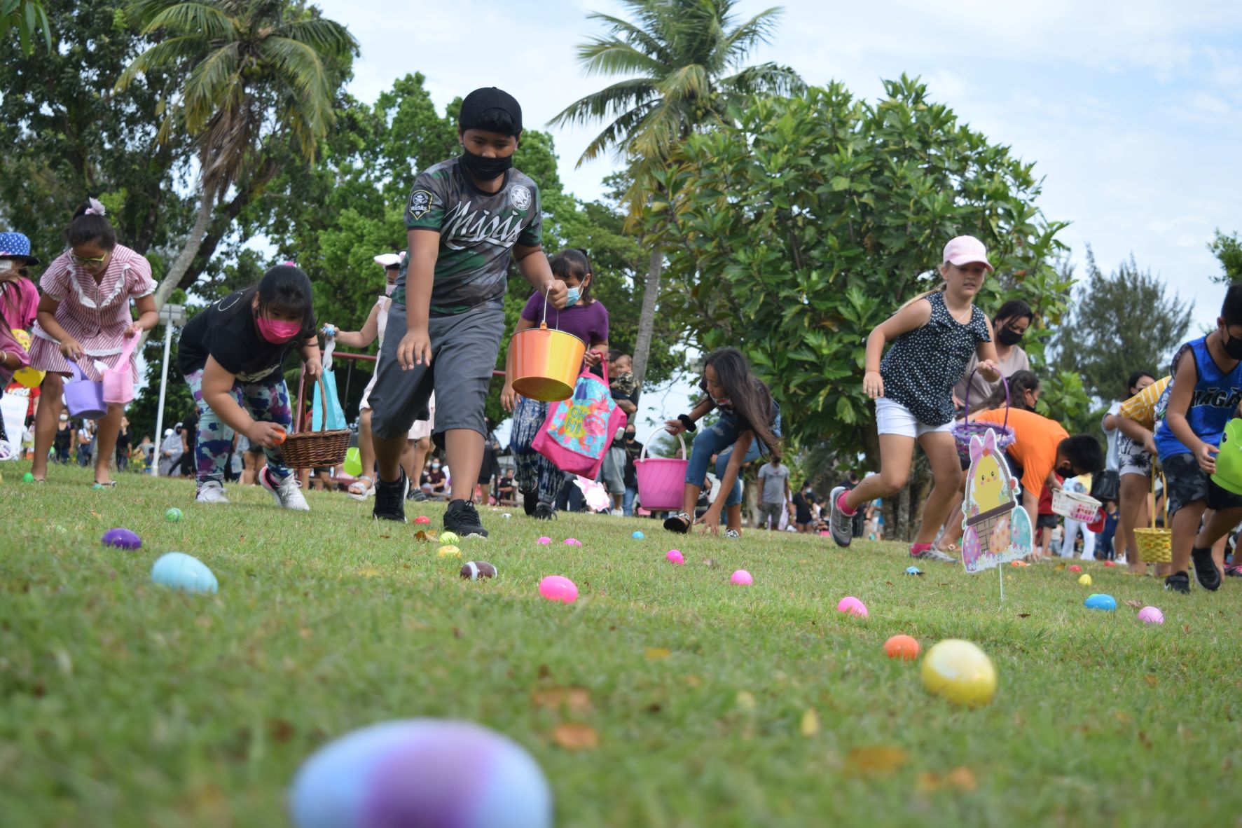 Children pick up Easter eggs during the Rotary Club of Saipan's Community Egg-Stravaganza Easter egg hunt at Sugar King Park in Garapan on Saturday.