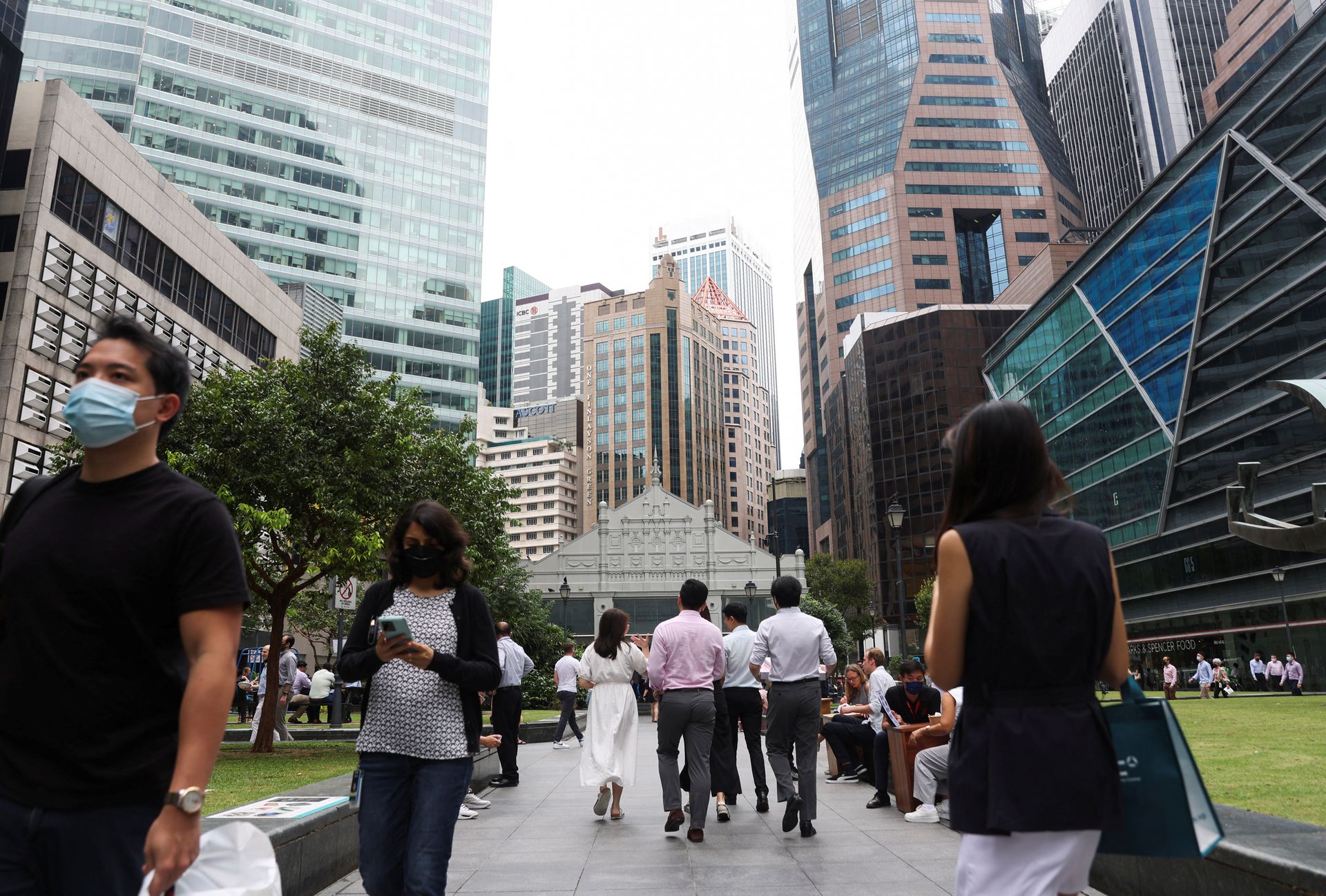 Office workers go for lunch at the central business district on the first day free of coronavirus disease restrictions in Singapore, April 26, 2022.