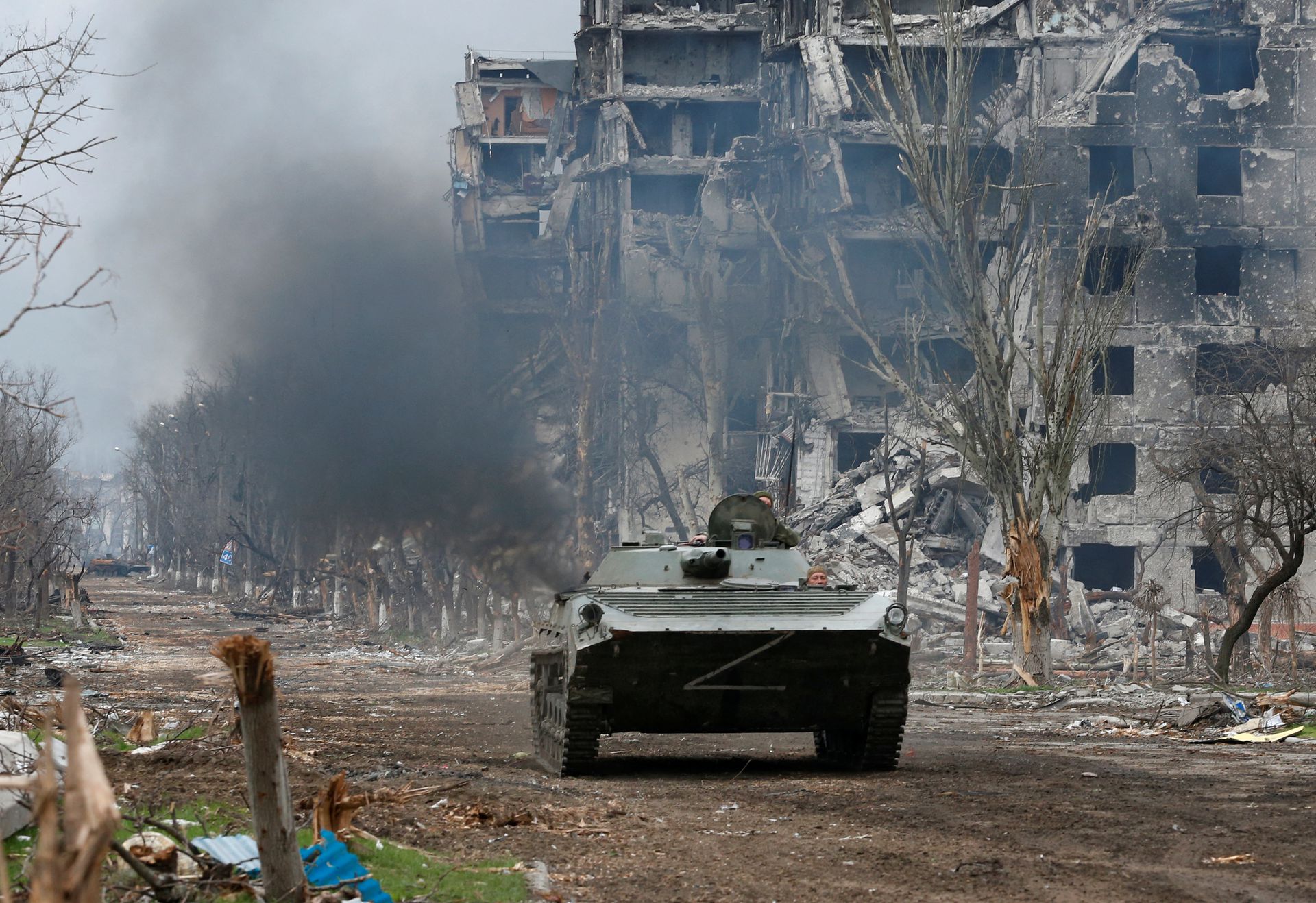 Service members of pro-Russian troops ride an armored vehicle during fighting near a plant of Azovstal Iron and Steel Works company in the southern port city of Mariupol, Ukraine on April 12, 2022.