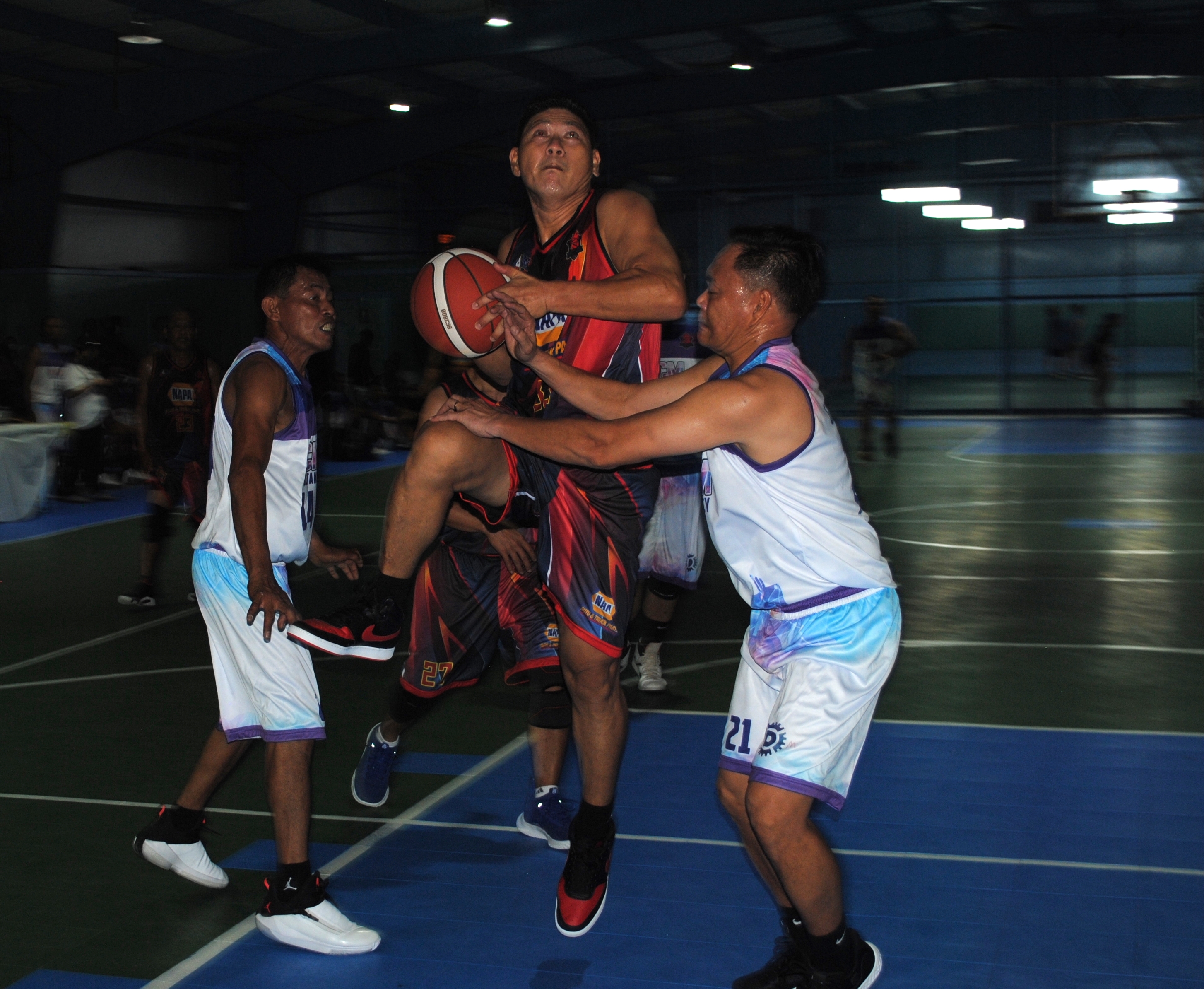 NAPA's De Guzman gets fouled as he goes up for the shot during a master's division game of the Saipan Centennial Lions Club Basketball League at the TSL Sports Complex.