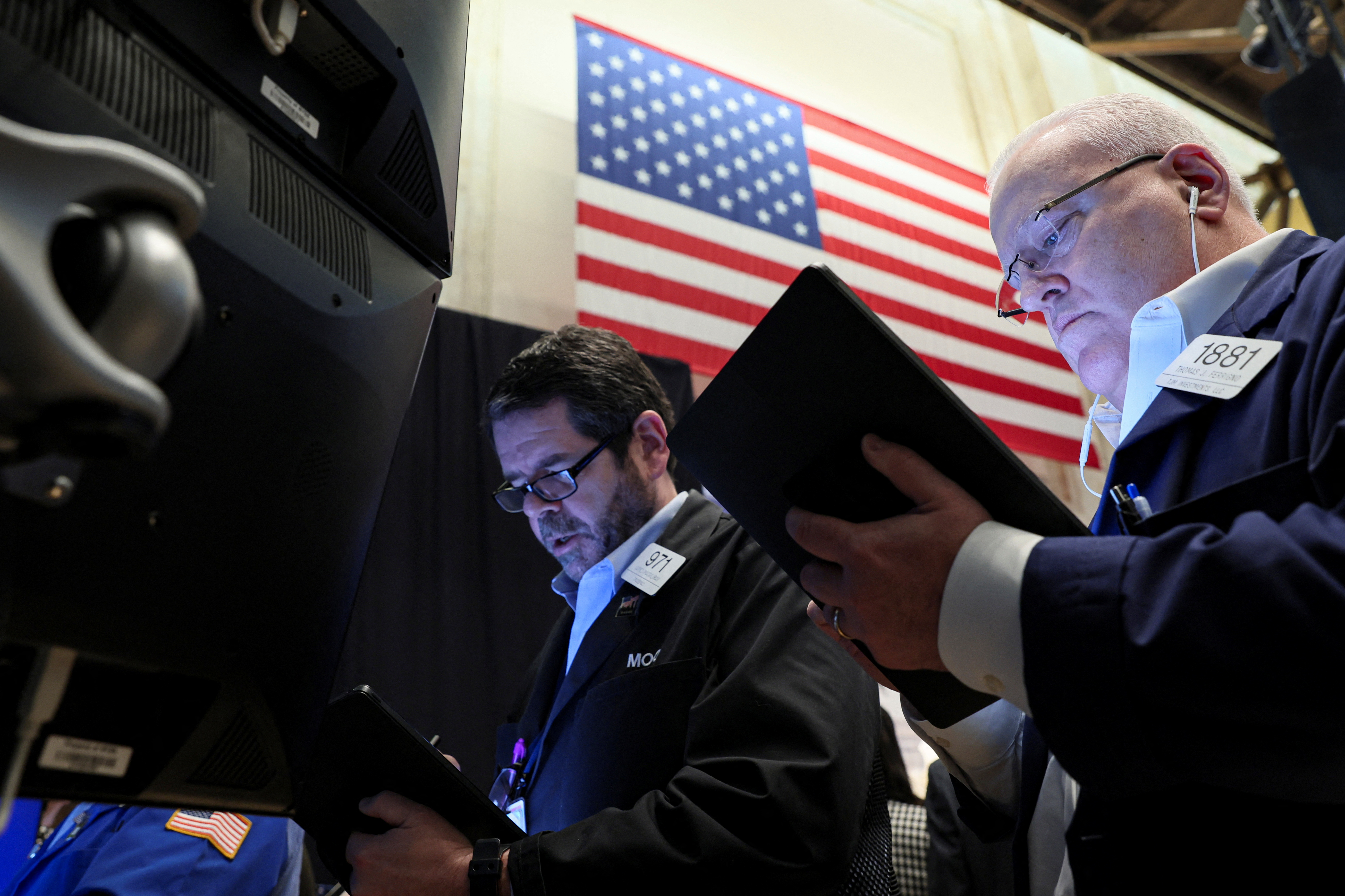 Traders work on the floor of the New York Stock Exchange  in New York City, March 30, 2022.