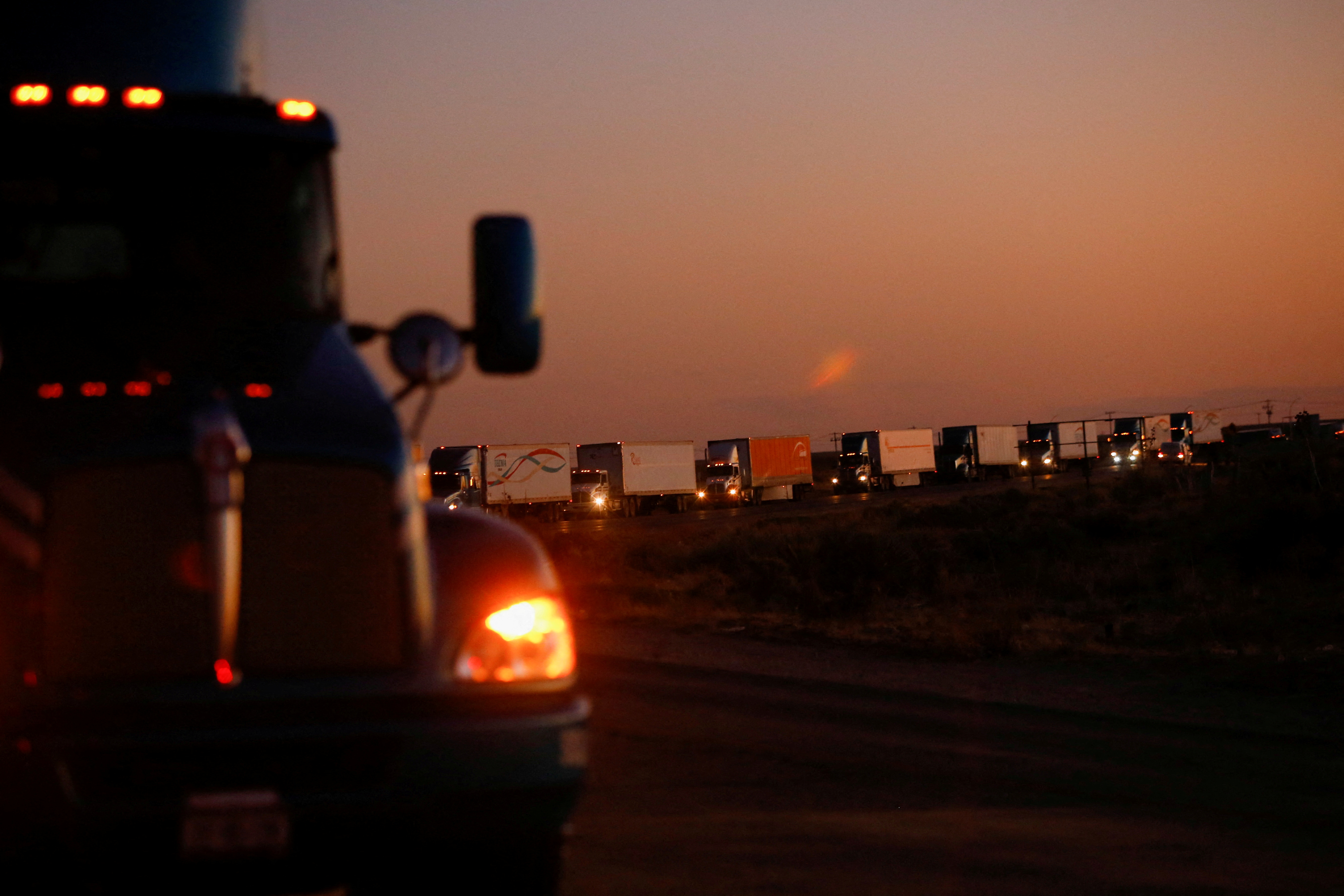 Trucks wait in a queue to cross into the United States in the Jeronimo-Santa Teresa International Bridge connecting the city of Ciudad Juarez to Santa Teresa, Nuevo Mexico after Texas Gov. Greg Abbott announced Friday that traffic commercial trucks from Chihuahua to Texas will return to normal immediately following a border security agreement with the governor of the Mexican state.