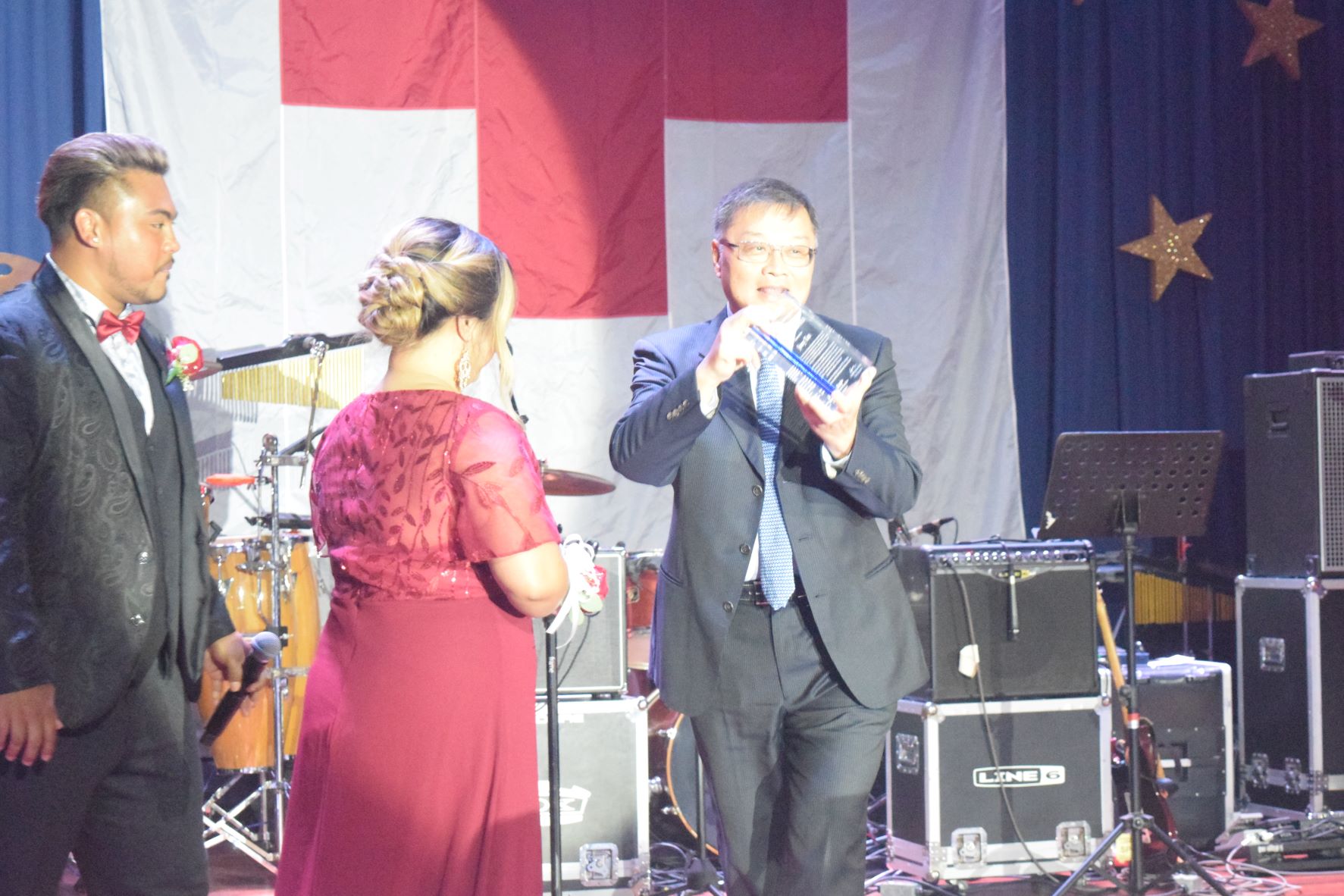 Tan Holdings Corp. President and CEO Jerry Tan holds his Humanitarian Leadership Award as American Red Cross-NMI Chapter Chair Natalie Mable Ayuyu-Glenn and Vice Chair Dr. Bobby Cruz look on during the Red Gala at Kensington Hotel  on Saturday.