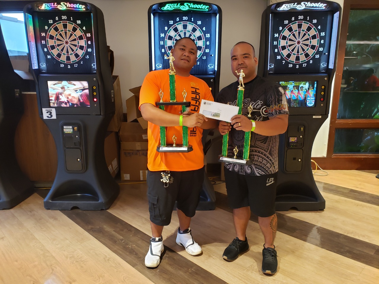 Christian Omnes, left, and Michael Muna pose with the 1st place trophy after winning the blind draw tournament during the SEDA Bud Light League awards banquet Saturday at the Pacific Islands Club.