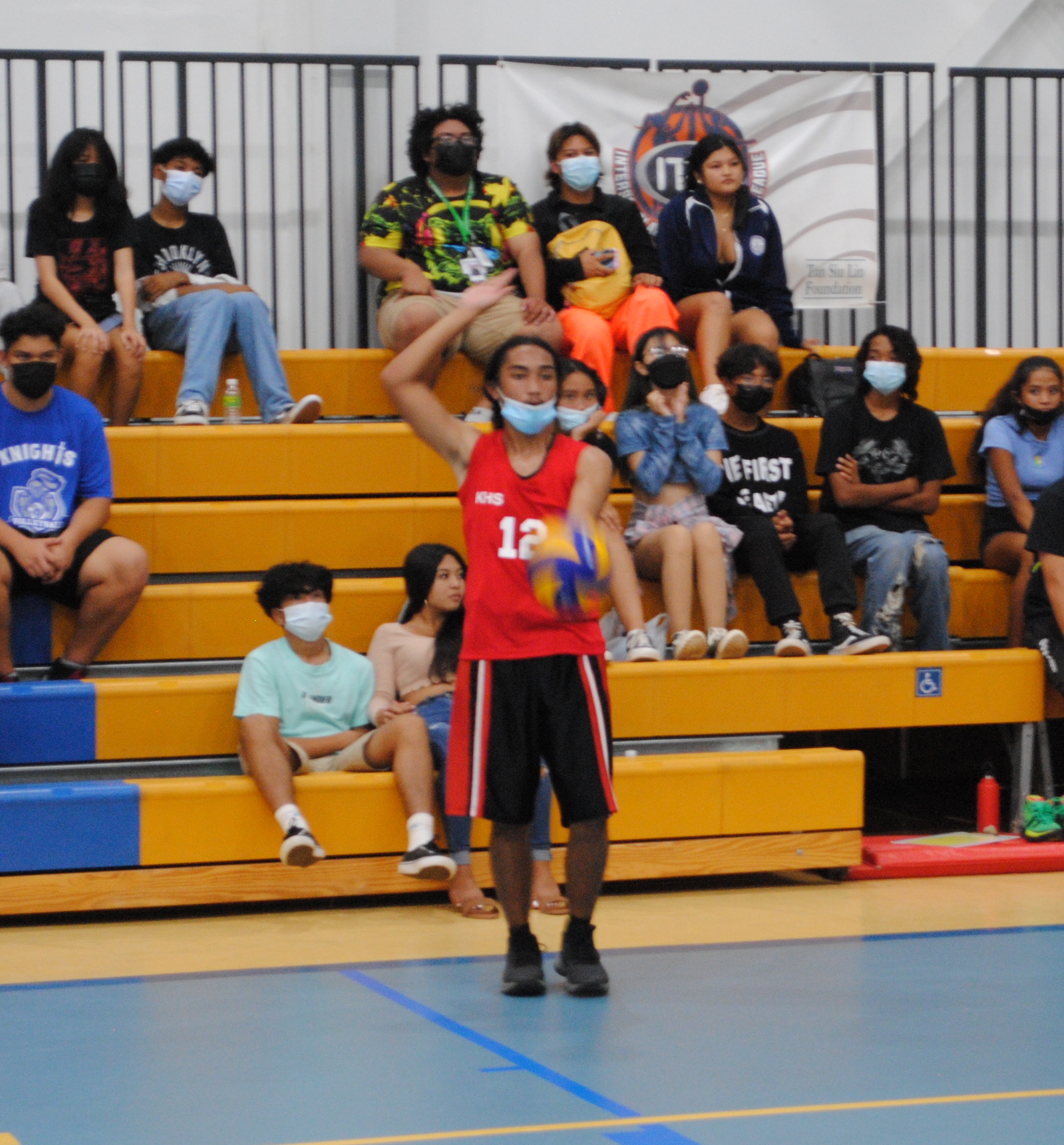 A KHS player preps for the overhead serve during a PSS Boys High School Volleyball game Saturday at the MHS gym.