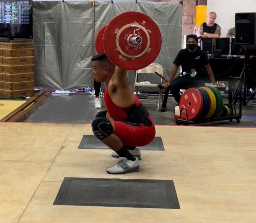 Joey Tudela attempts the snatch during the Guam Weightlifting Open Championship in Tamuning, Guam on March 26, 2022.