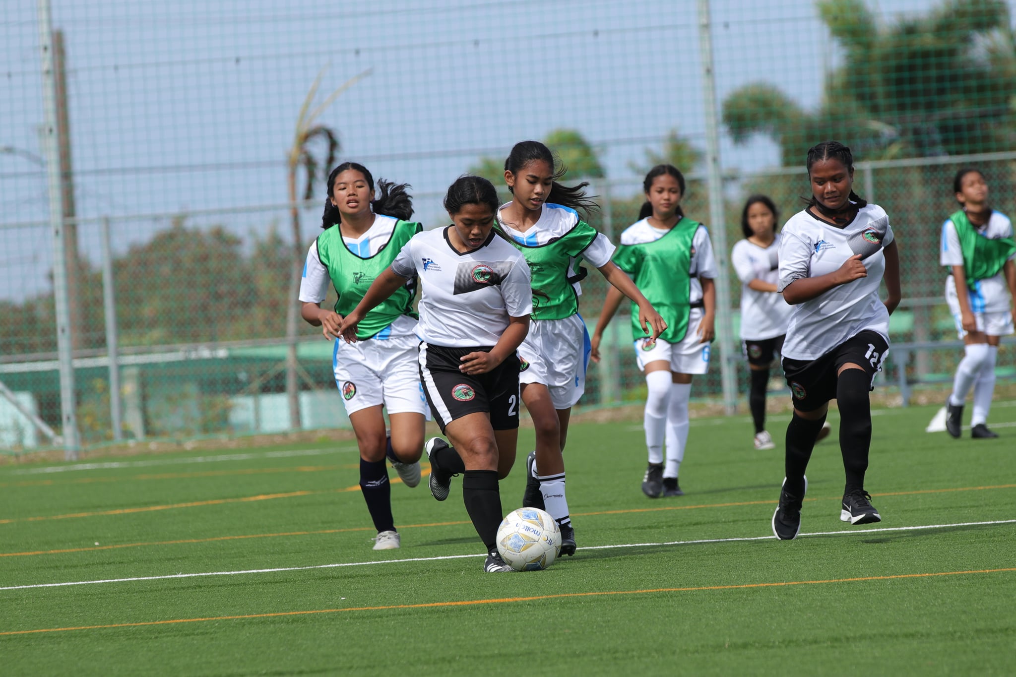 Chacha’s Justidy Mizutani pushes forward after passing defenders during a game against Tinian on Saturday, April 2, at the NMI Soccer Training Center.
