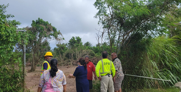 HPO’s  Rita Chong, Linda Torres and Jay Fitial, DPW’s Dwayne Muna and IRP Archaeology Team discuss temporary parking lot progress east of the Oleai Sports Complex track and field.