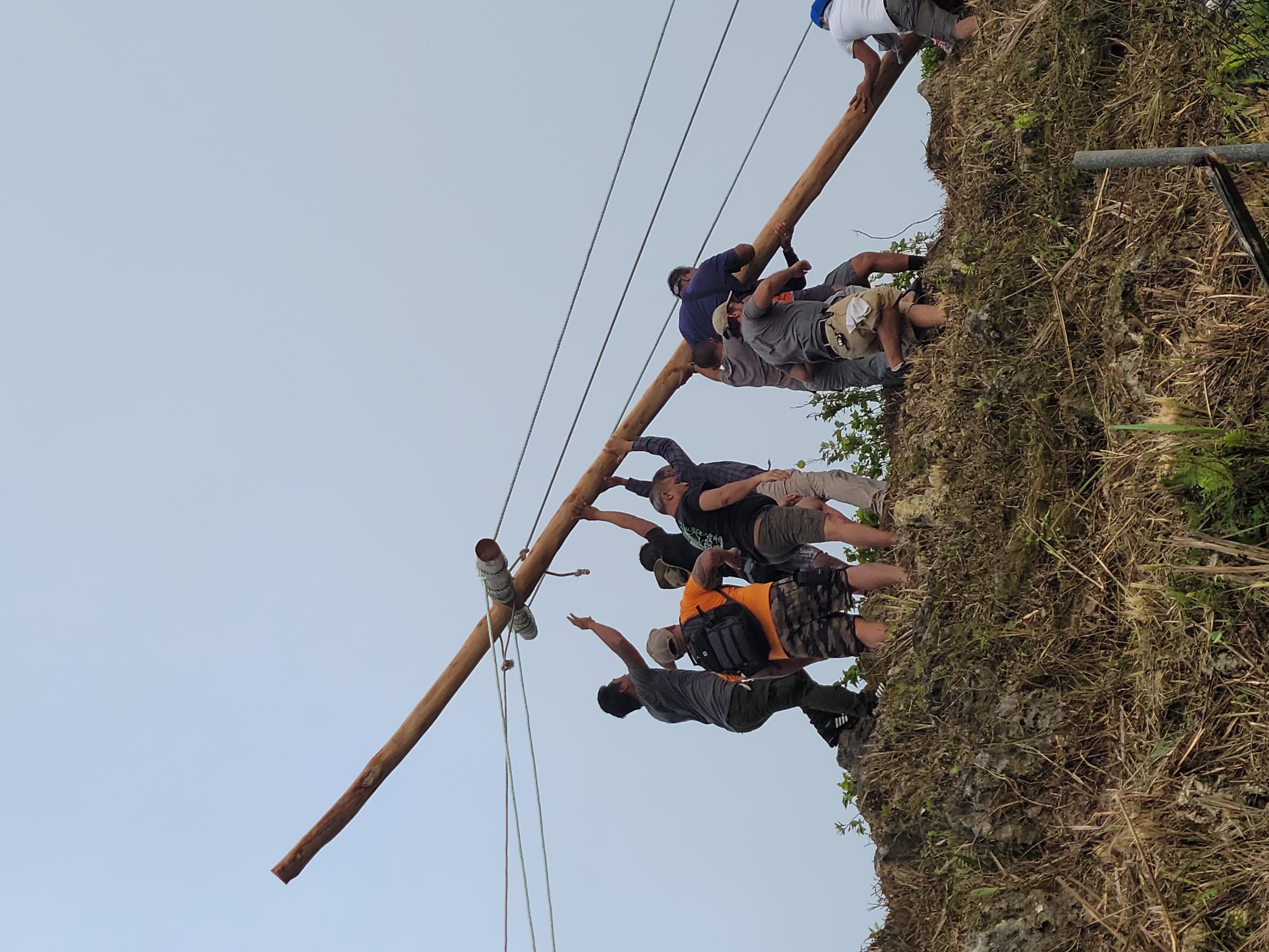 Devotees erect a 30-foot wooden cross on Mount Tapochao on Good Friday.