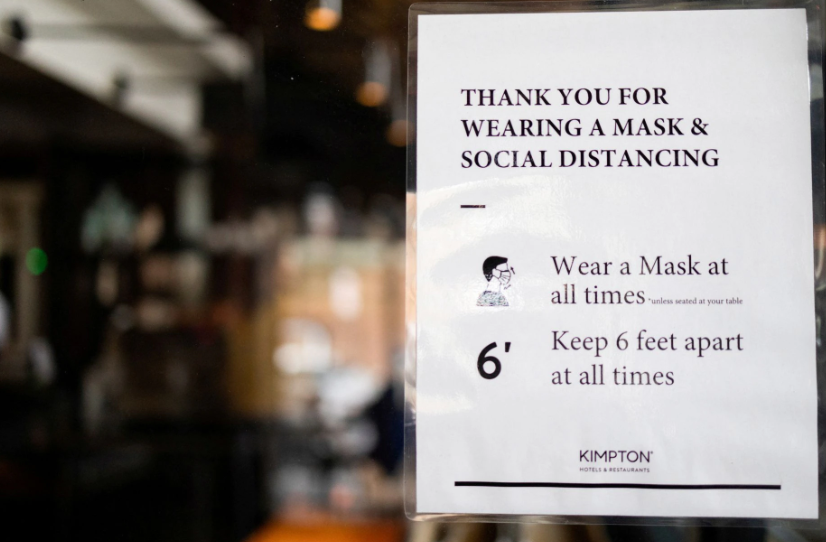 A sign is seen in a dining area that has been modified to prevent the spread of coronavirus disease at the Kimpton Hotel Monaco in Philadelphia, Pennsylvania, April 7, 2021.