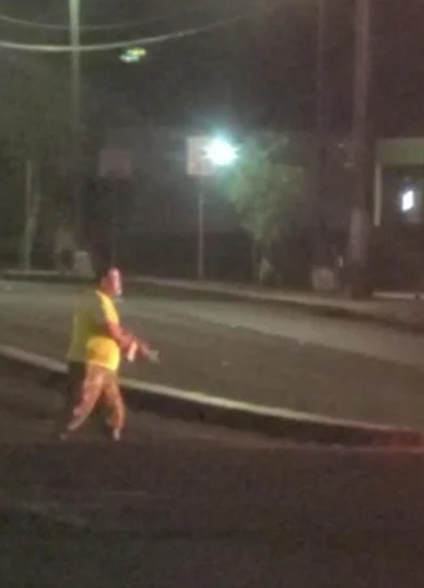 A screengrab from a reader-contributed video shows a motorist running out of his burning SUV and carrying what looked like a rifle after a high-speed chase in Harmon on Friday morning. Moments later, after numerous police warnings for him to drop his gun, police shot him.