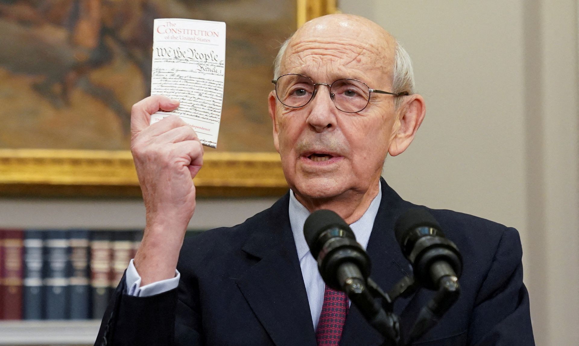 U.S. Supreme Court Justice Stephen Breyer holds up a copy of the U.S. Constitution as he announces he will retire at the end of the court's current term, at the White House in Washington, D.C., Jan. 27, 2022.
