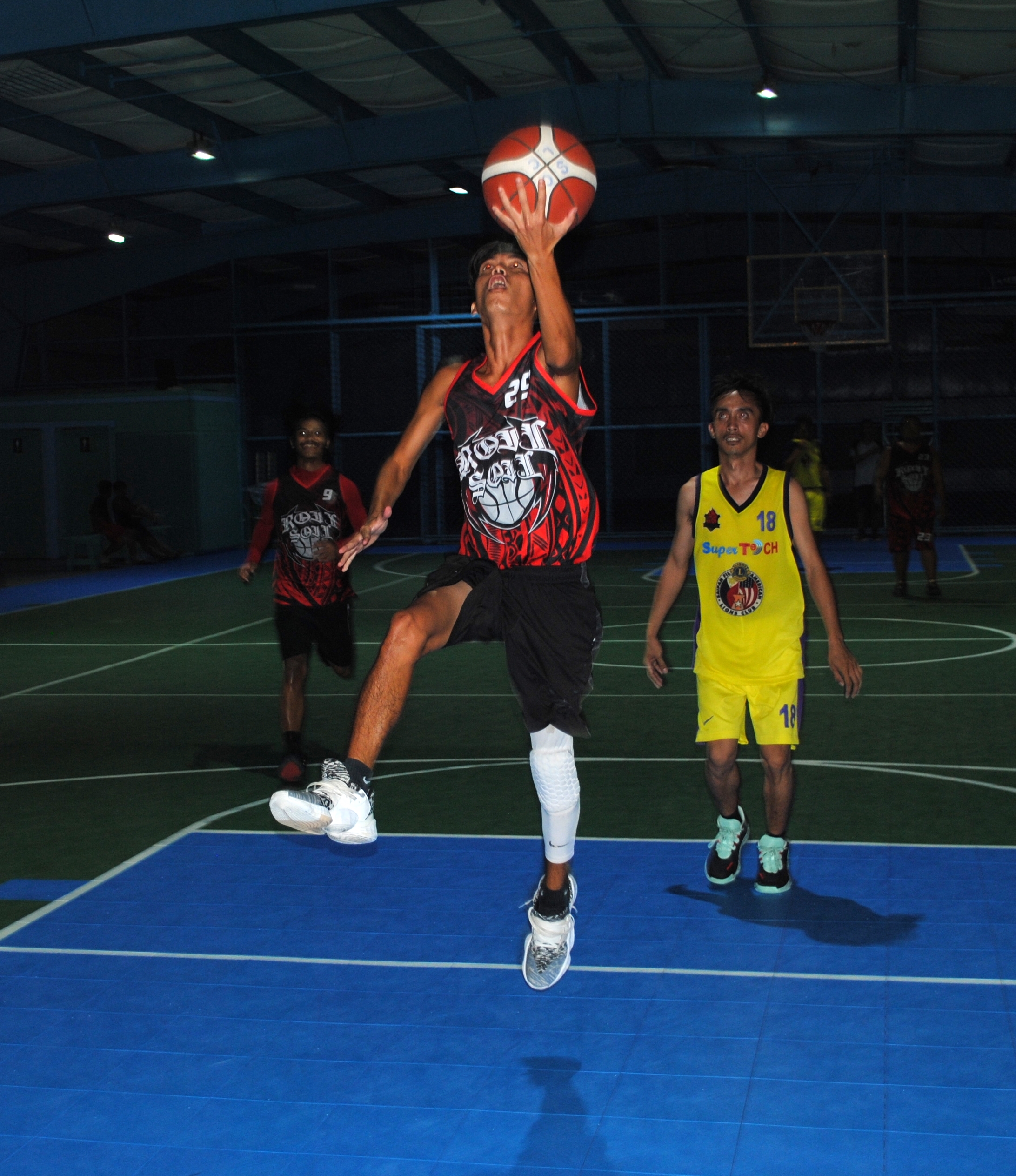 Paradise Realty's Castro extends for the left-hand finish during an open division game of the Saipan Centennial Lions Club Basketball League on Friday at the TSL Sports Complex.