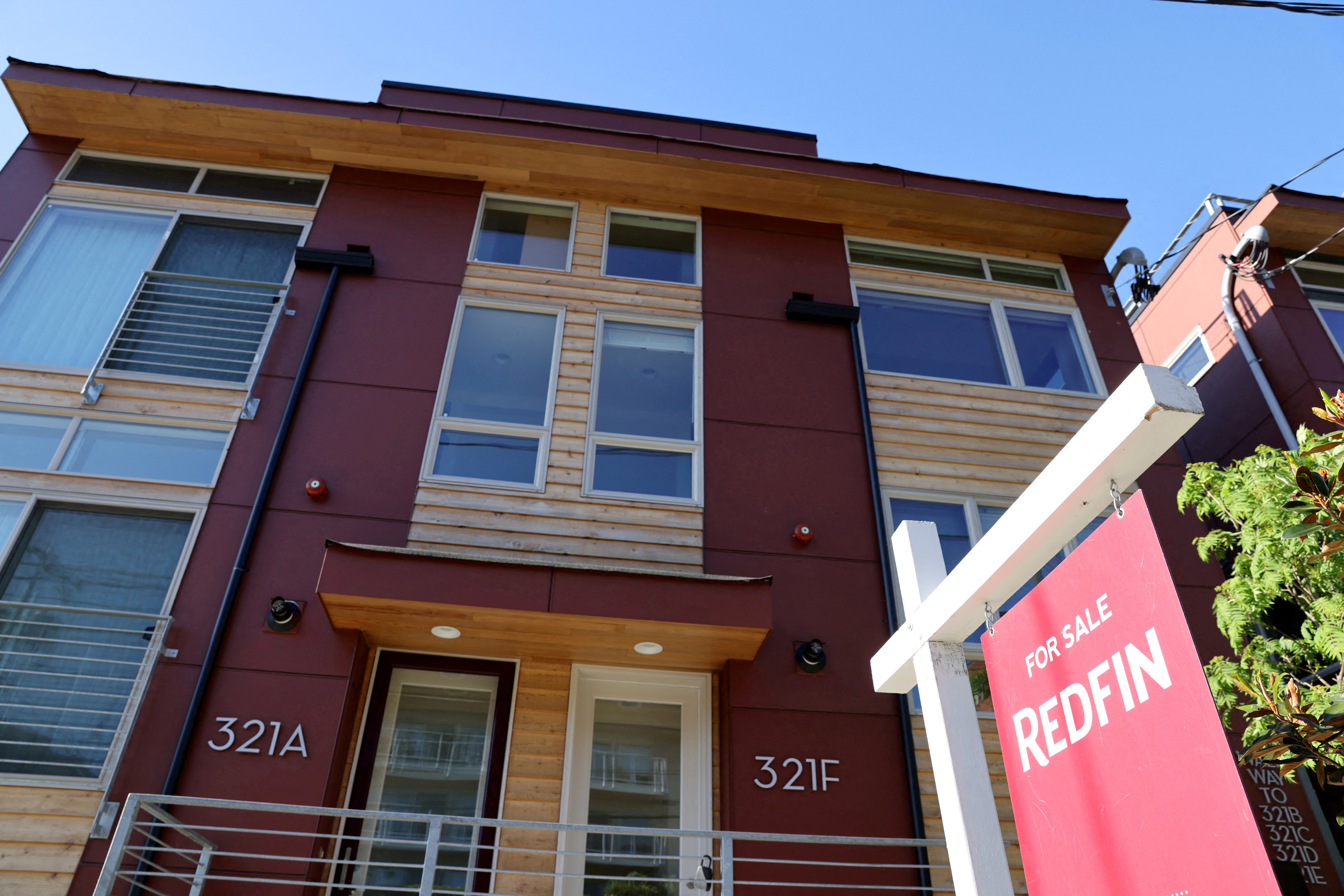 A "For Sale" sign is posted outside a residential home in the Queen Anne neighborhood of Seattle, Washington,  May 14, 2021.