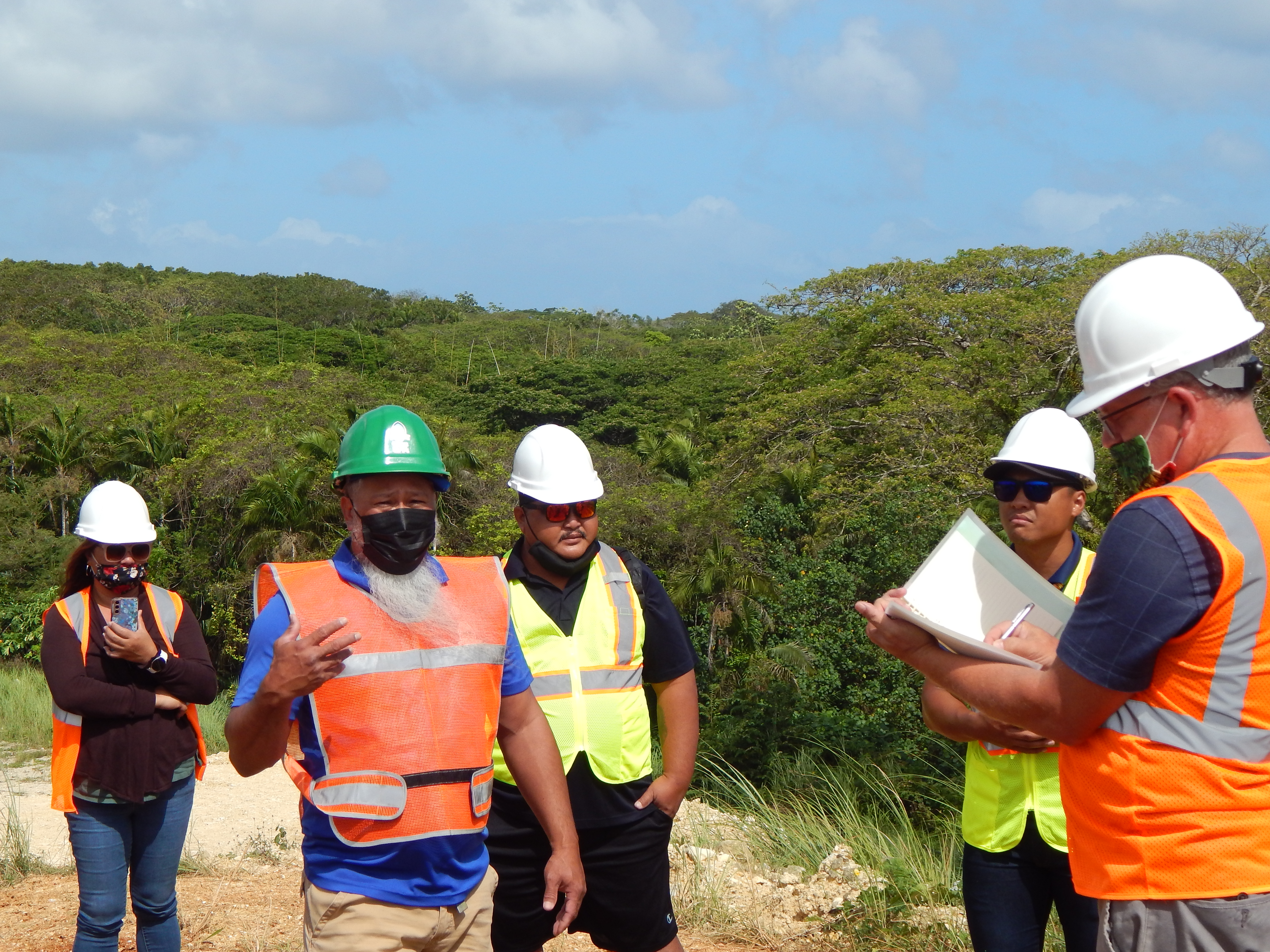 Guam Environmental Protection Agency Solid Waste Program Manager Glenn San Nicolas, second from left, walks representatives from the CNMI Office of Planning and Development, Department of Public Works  Tinian, and the Bureau of Environmental and Coastal Quality  through the UMS Hardfill site in Mangilao, Guam.