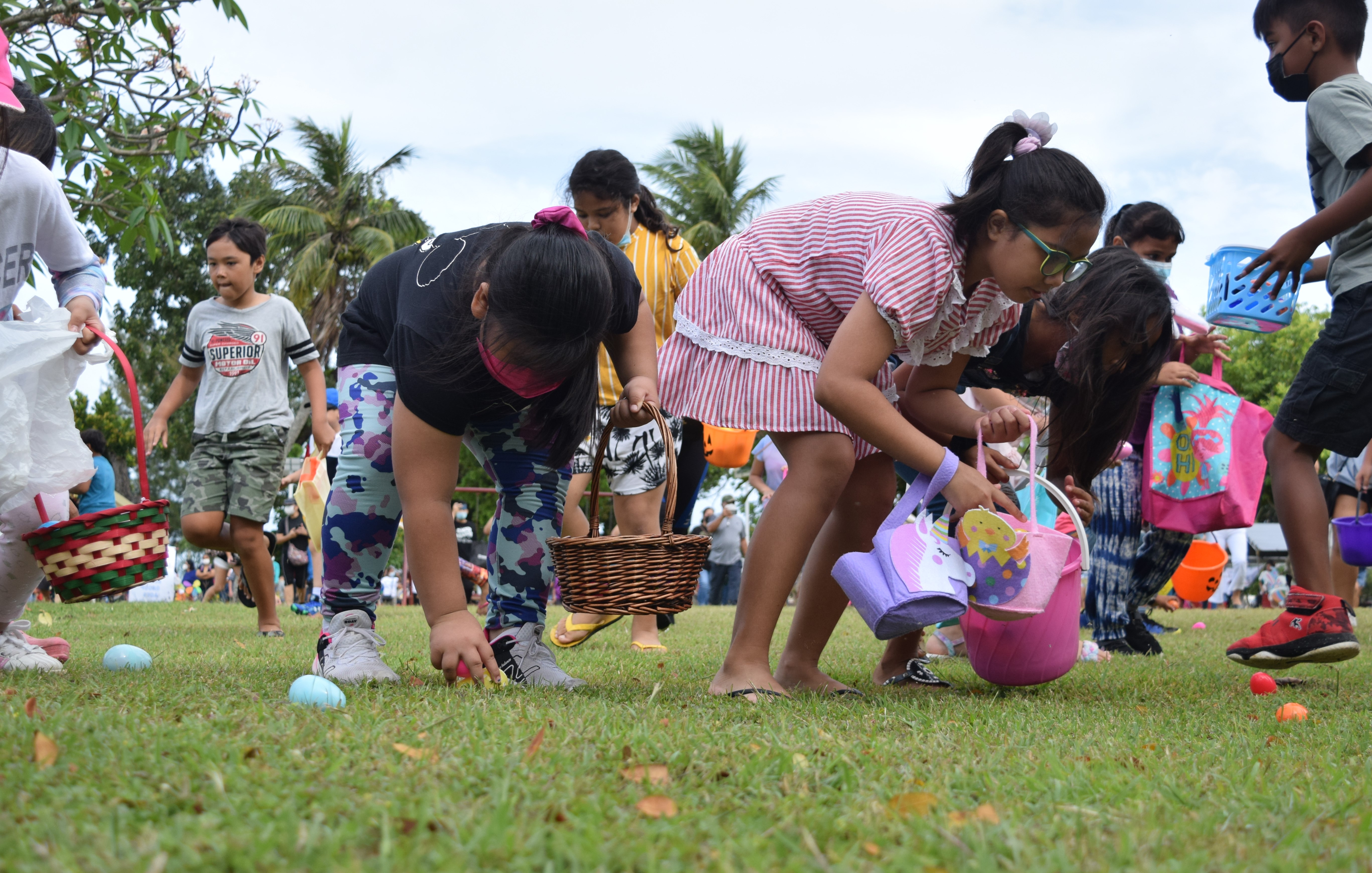 Children pick up Easter eggs.