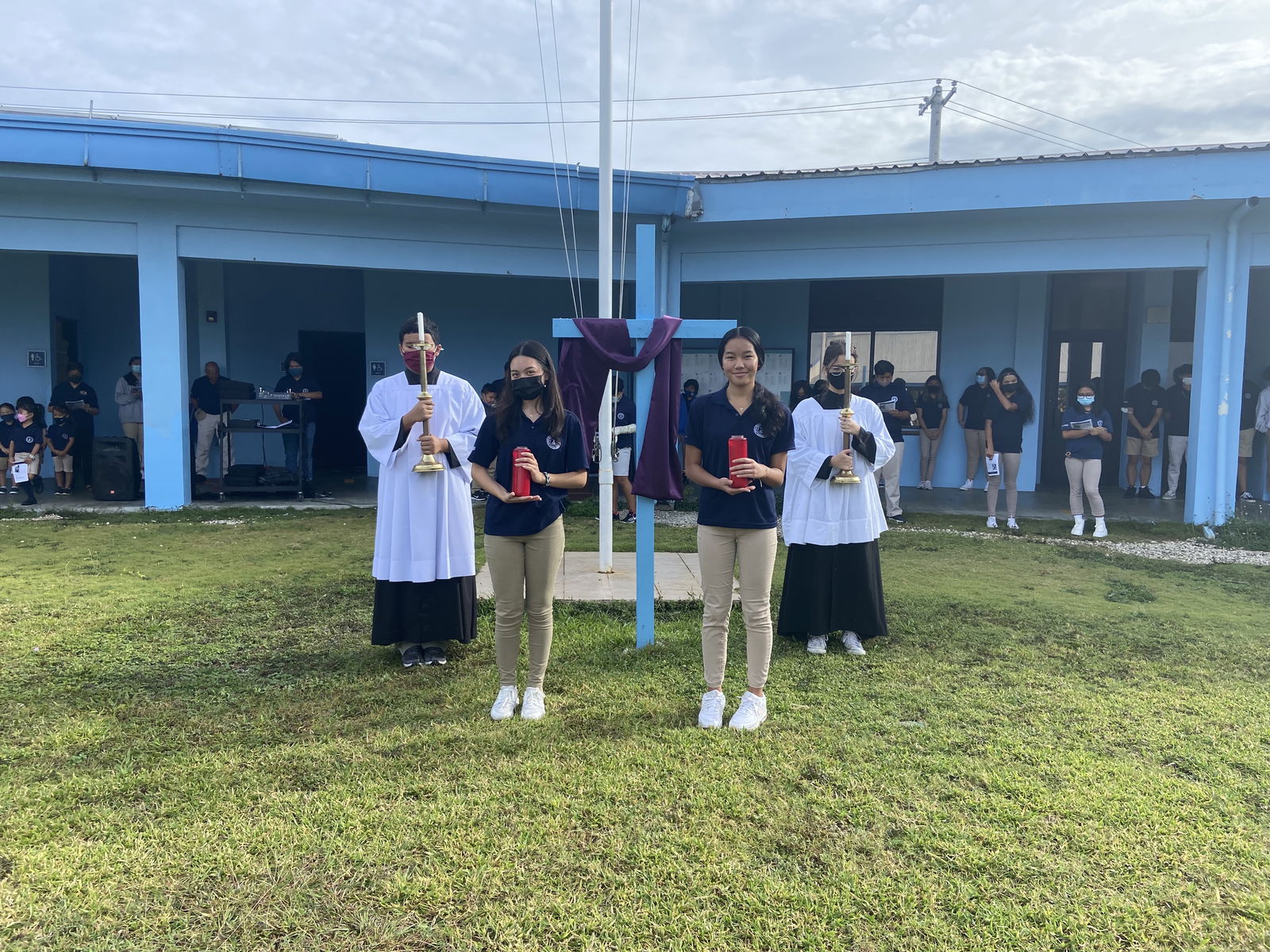 Mount Carmel School students position themselves with candles during “The Eleventh Station Jesus Nailed to the Cross” during the Stations of the Cross.