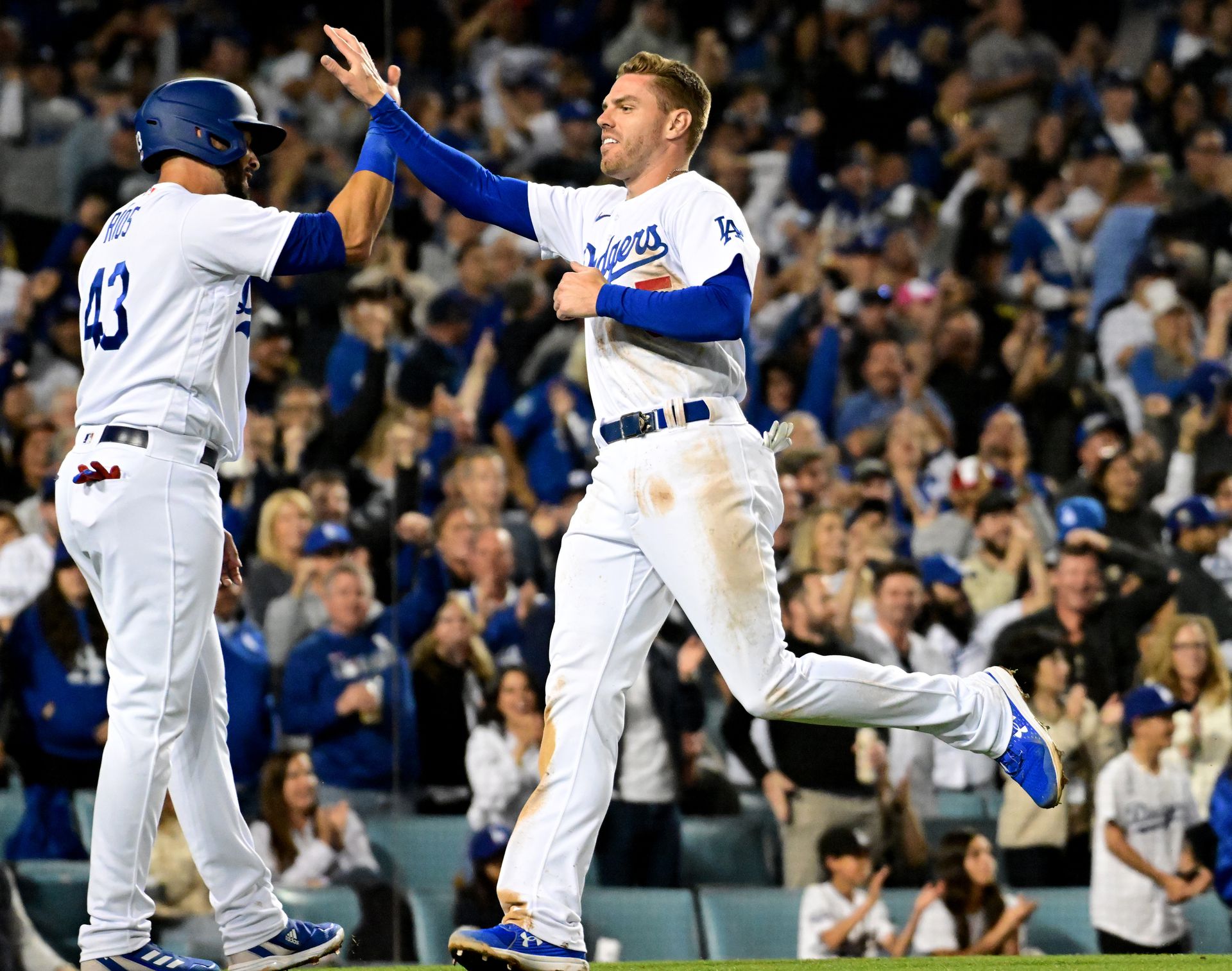 Los Angeles Dodgers first baseman Freddie Freeman (5) celebrates with Los Angeles Dodgers third baseman Edwin Rios (43) after scoring in the fourth inning against the Atlanta Braves at Dodger Stadium in Los Angeles, California on April 18, 2022.