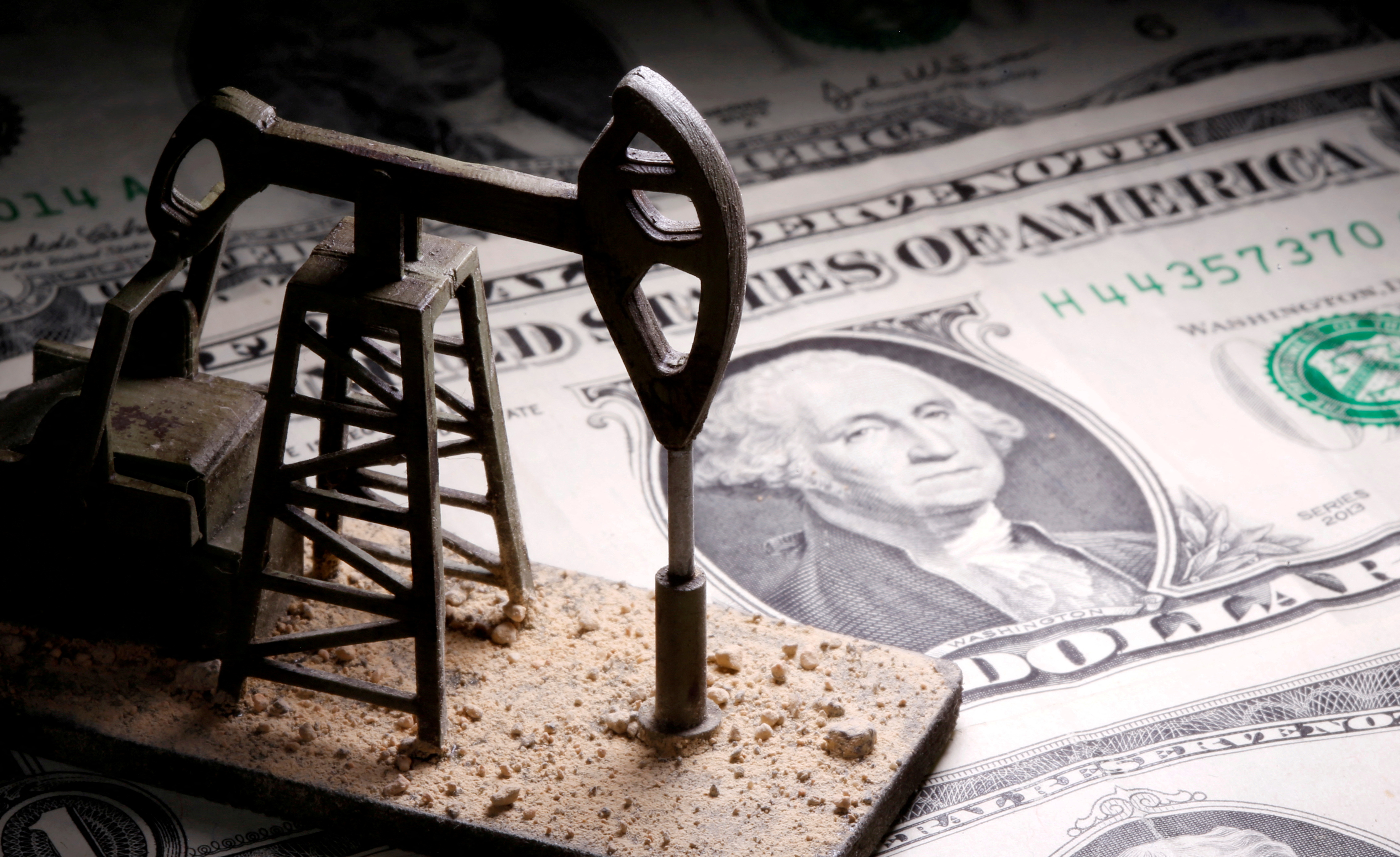 A 3D-printed oil pump jack is placed on dollar banknotes in this illustration picture, April 14, 2020.