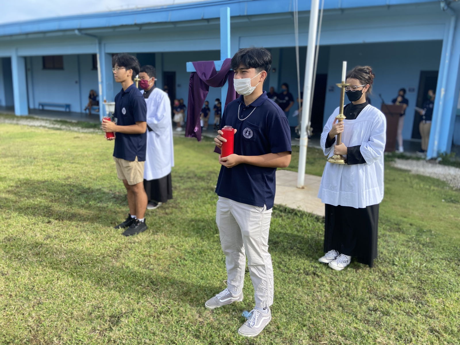 Mount Carmel School students position themselves with candles during “The Twelfth Station Jesus Dies on the Cross” during the Stations of the Cross.