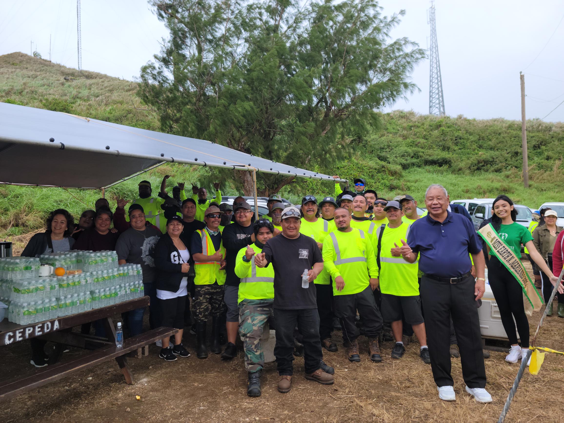Saipan Mayor David M. Apatang, right foreground, poses for a photo with Miss Northern Marianas Earth 2021 Crystal Fiona Rio, right background, the mayor’s staffers and other volunteers.
