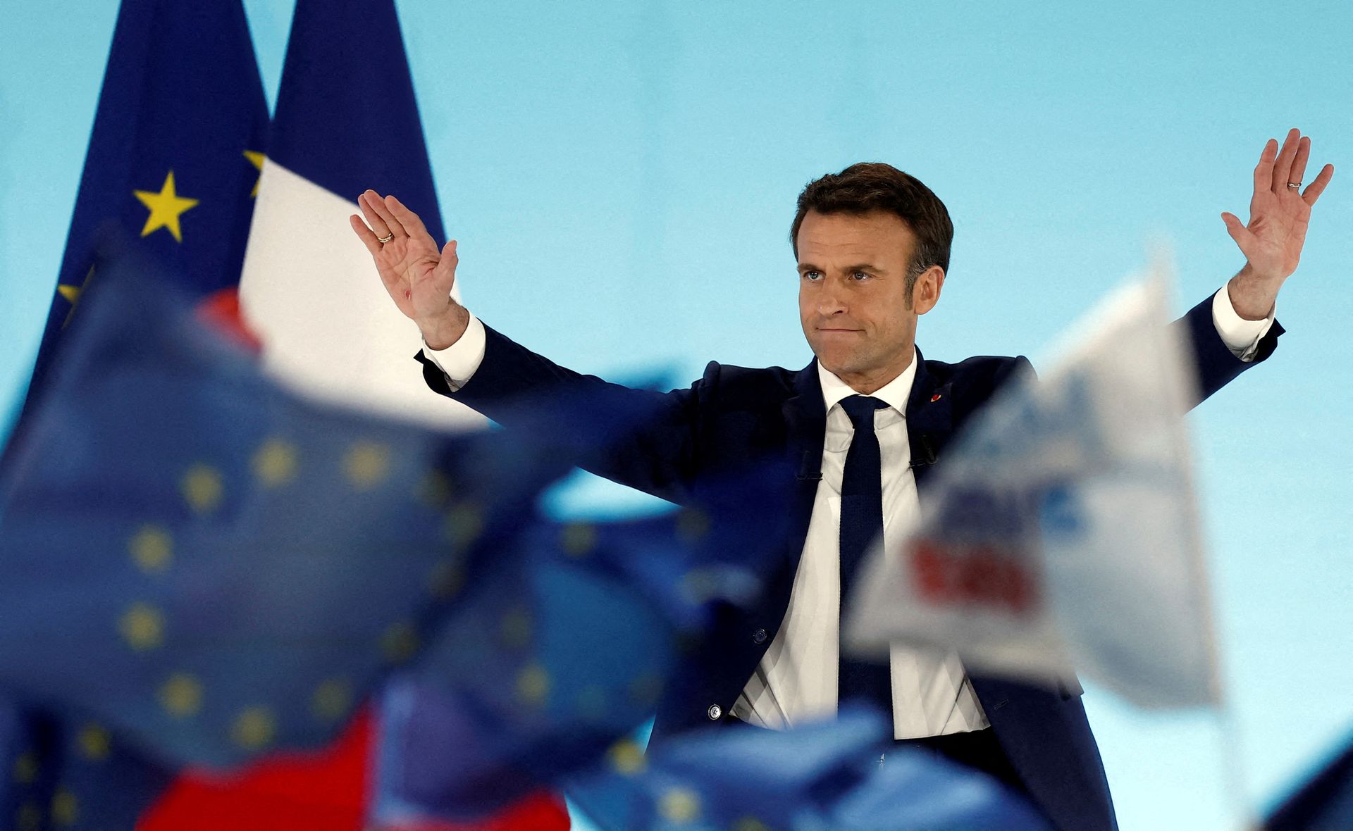 French President Emmanuel Macron, who is seeking re-election, reacts on stage after the announcement of the partial results in the first round of the 2022 French presidential election in Paris, France, April 10, 2022.