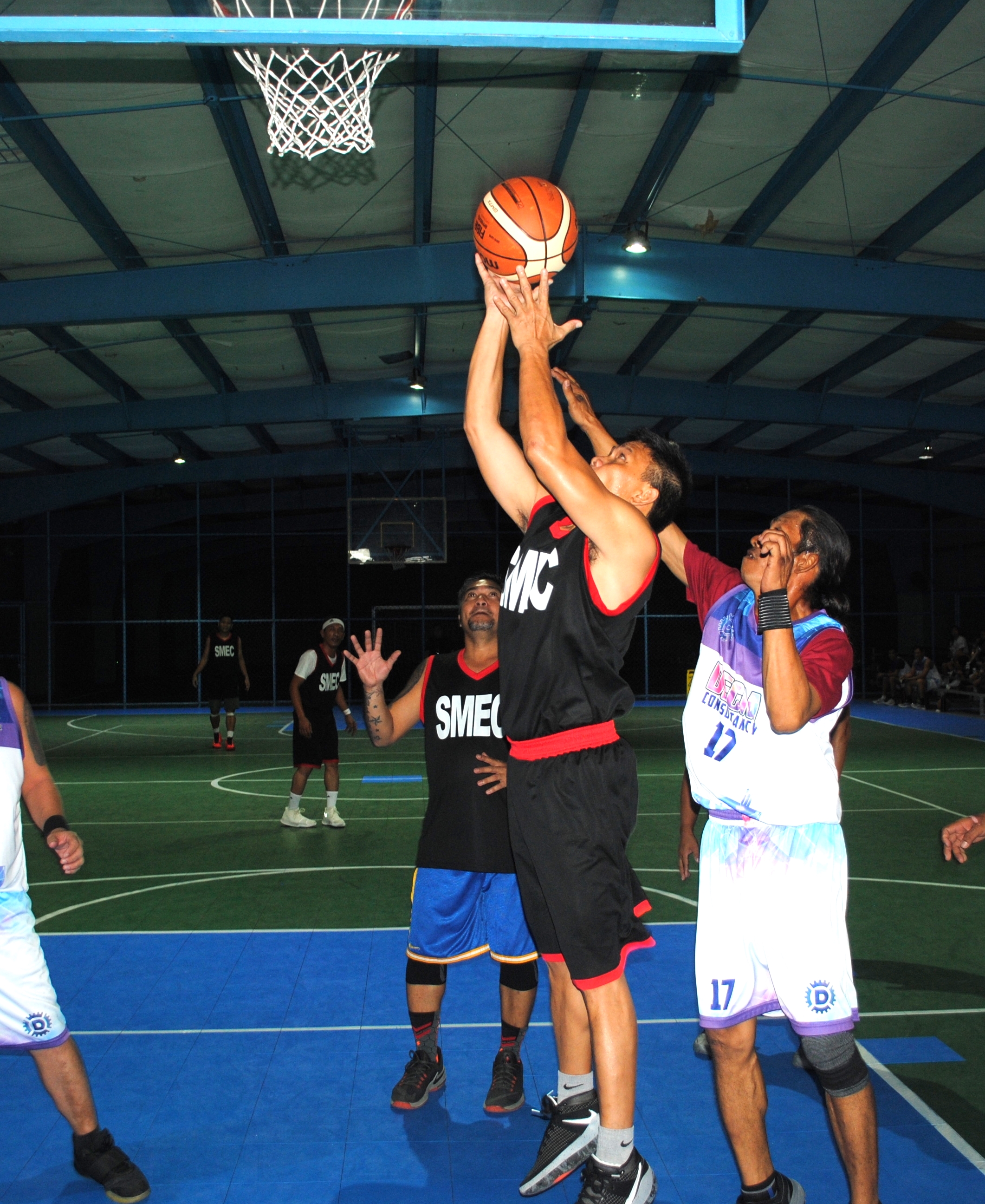 SMEC's Brillo extends for the finish from underneath during a Masters Division game of the Saipan Centennial Lions Club Basketball League at the TSL Sports Complex on Saturday.