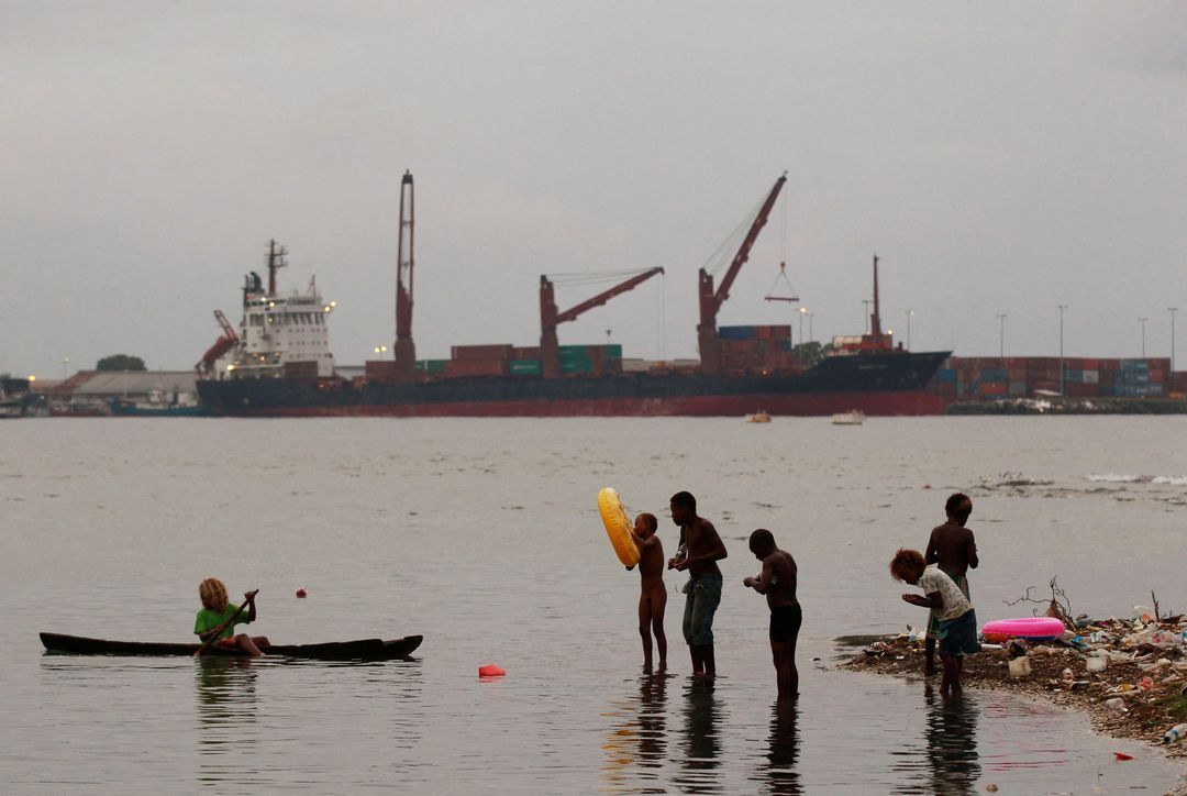 Children fish at a beach in central Honiara, the capital of the Solomon Islands, on Sept. 14, 2012.