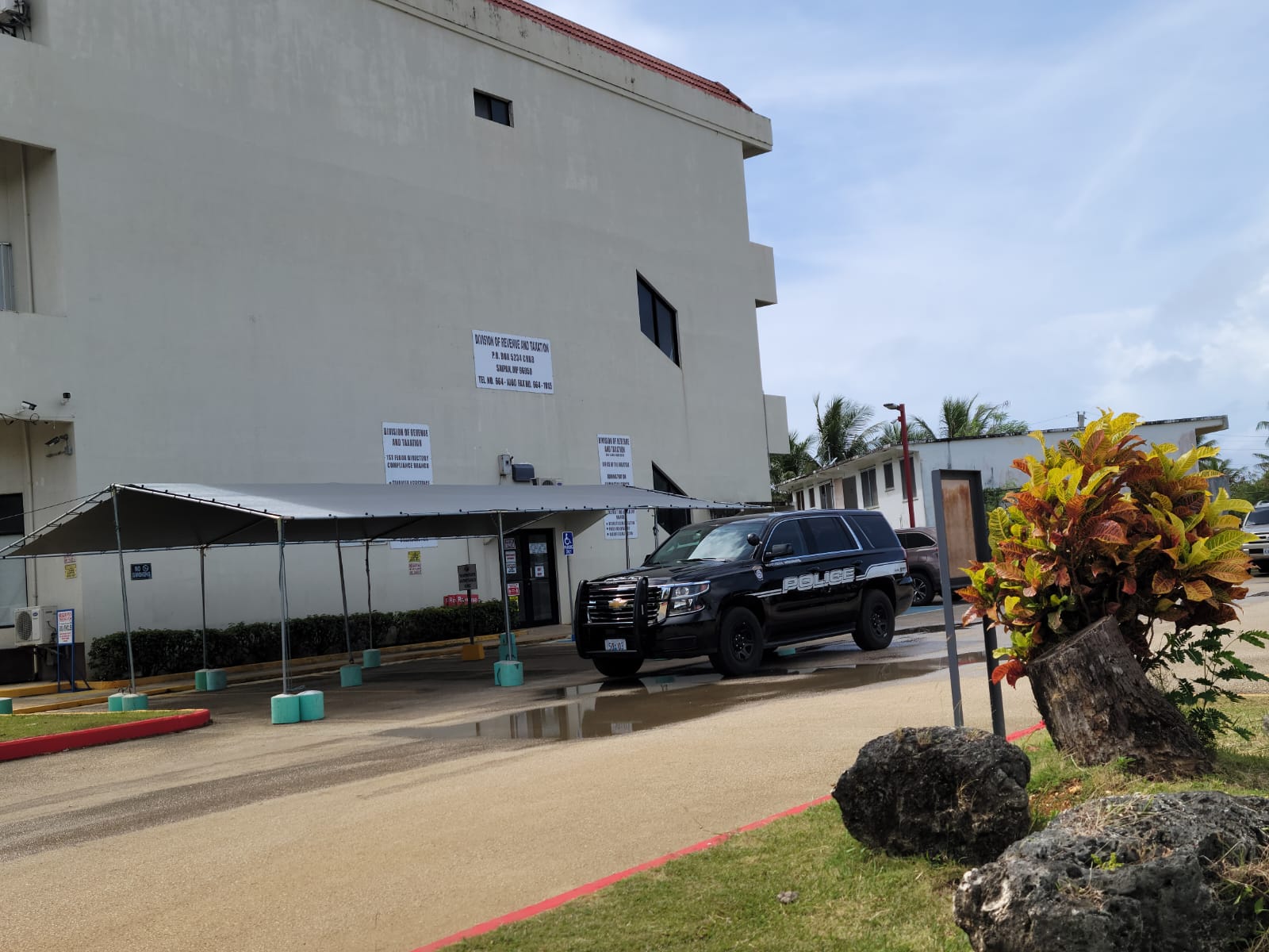 A police vehicle is seen outside the Division of Revenue and Taxation office in Dandan Friday.