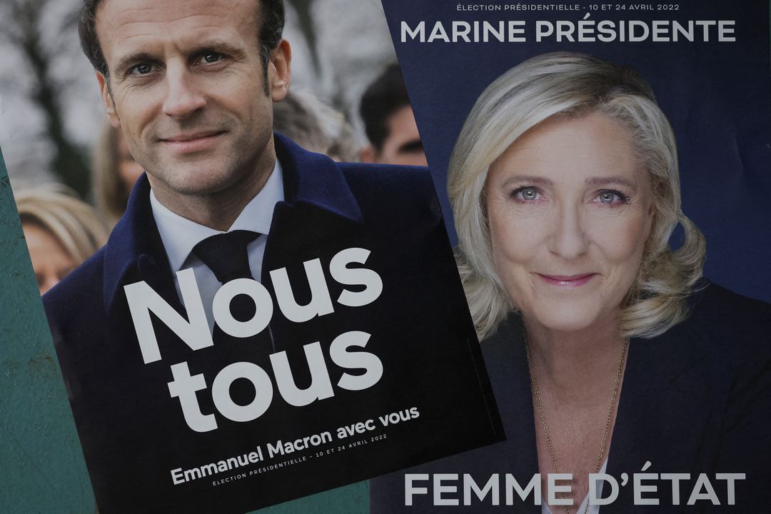 Official campaign posters of French President and centrist LREM party candidate for re-election Emmanuel Macron and Marine Le Pen, leader of French far-right National Rally or Rassemblement National party are displayed at France Affichage Plus dispatch hub in Mitry-Mory, outside Paris, France, March 22, 2022.