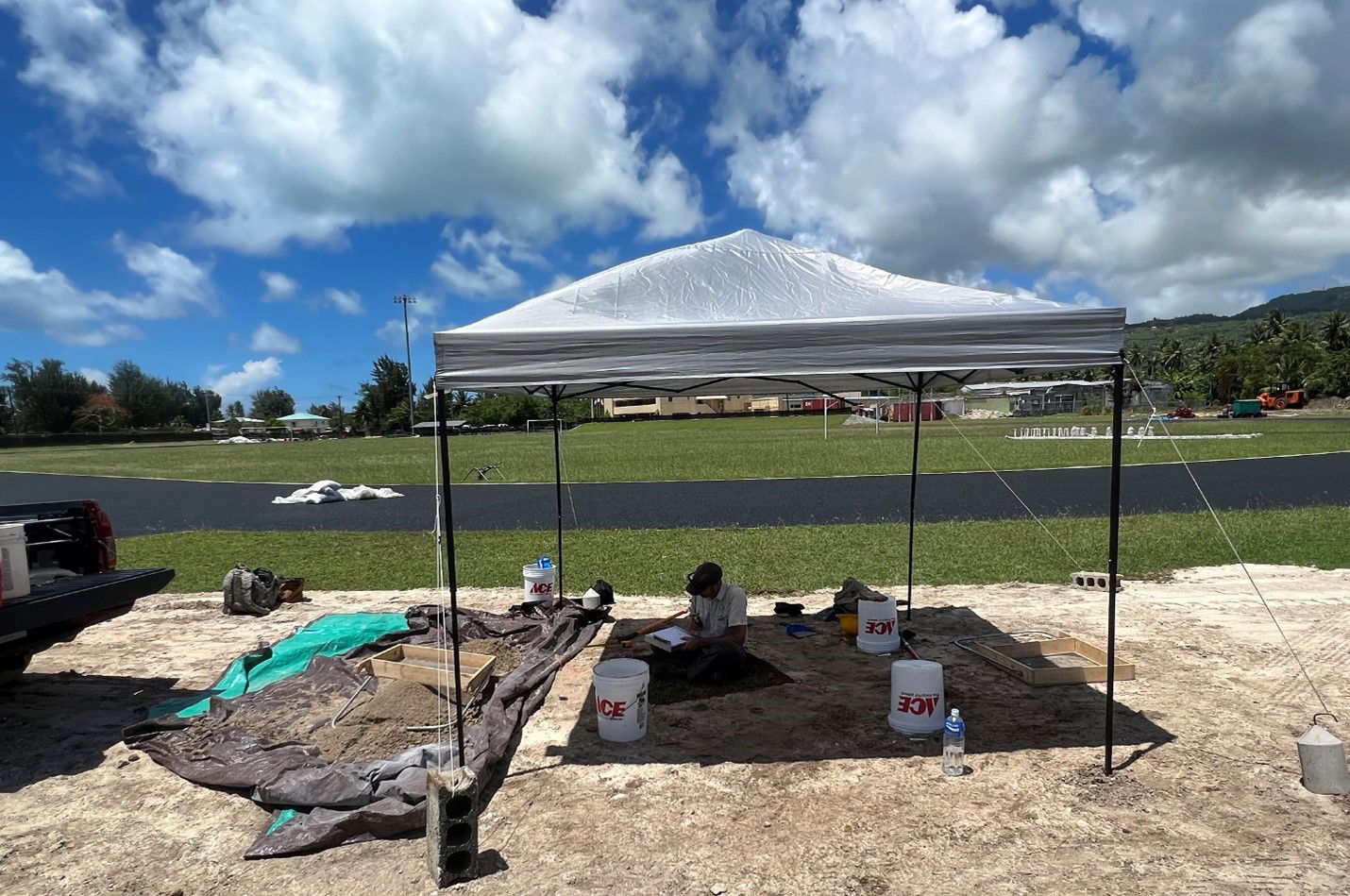 Historical, archeological consultation must be conducted in pursuant to CNMI P.L. 3-39 and the National Historic Preservation Act to obtain local and national project permits. IRP Archeologist Jeremy Freeman conducts archeological testing for a proposed light post location at the Oleai Sports Complex.