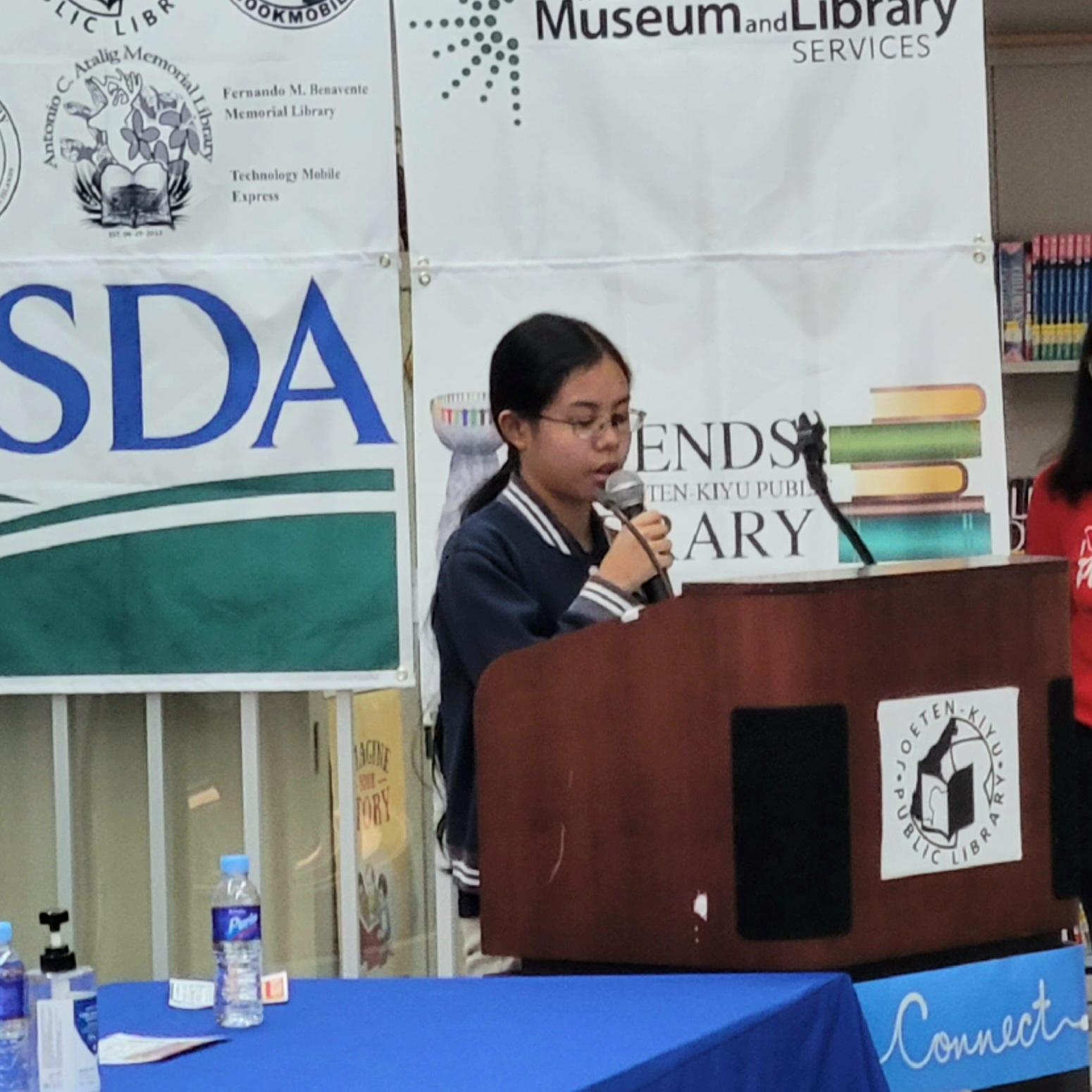 Youth Congress Floor Leader Yurihana DLG Sasamoto of Mount Carmel School reads the proclamation for National Library Outreach Day