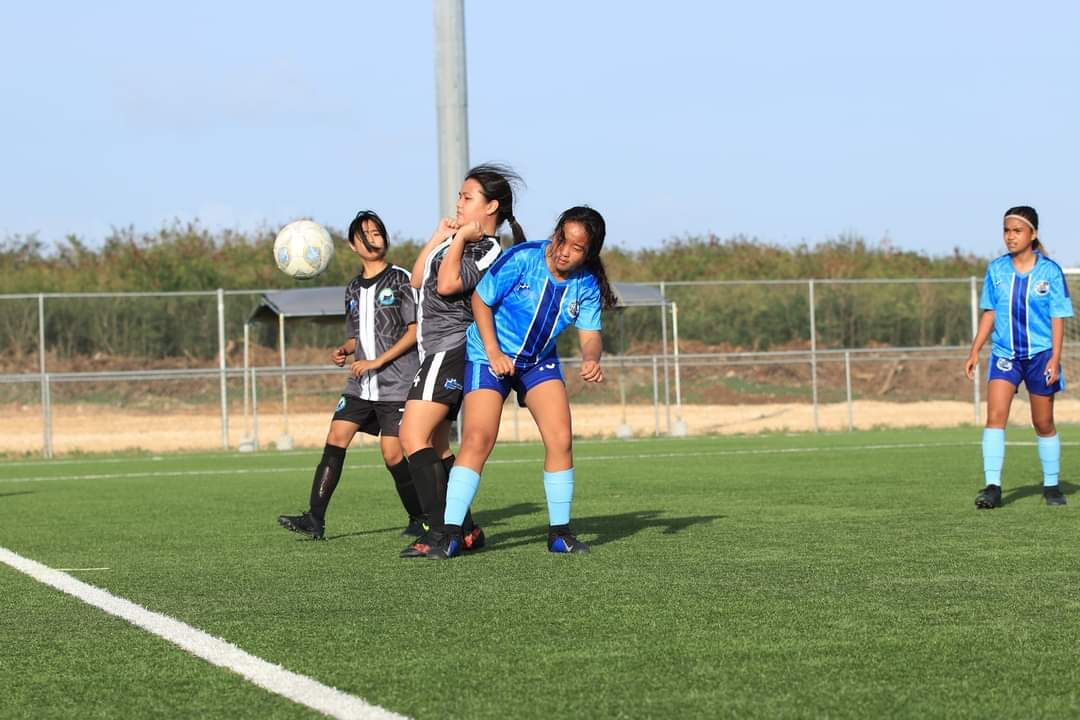 Saipan Southern High School’s Helen Baker attempts to control the ball as a Marianas High School 2 player closes in during a  girl's high school division game of the NMIFA-PSS Interscholastic Soccer League at the NMI Soccer Training Center.