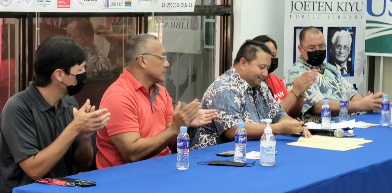 Gov. Ralph DLG Torres, third left, signs a proclamation in honor of the nation’s libraries.