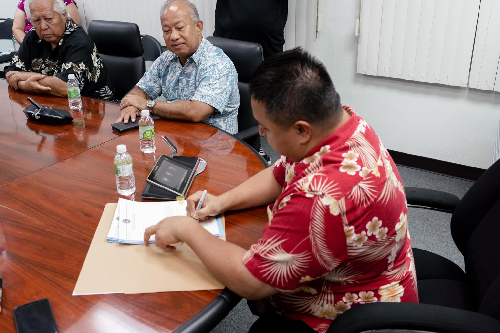 Gov. Ralph DLG Torres signs Public Law 22-17 which will provide each CNMI government retiree a $1,000 bonus. Looking on are retirees Pedro "Pange" Pangelinan and Jesus Taisague in the governor's conference room Thursday.
