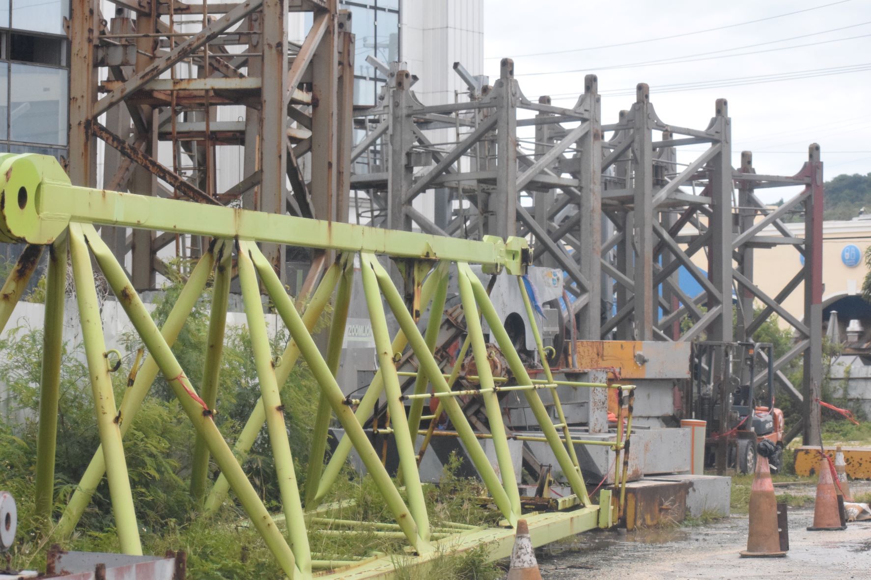Some of the parts of tower crane No. 6 that were removed last year are seen on the ground next to unfinished Imperial Pacific International casino-hotel in Garapan. Two other tower cranes are still on top of the building.