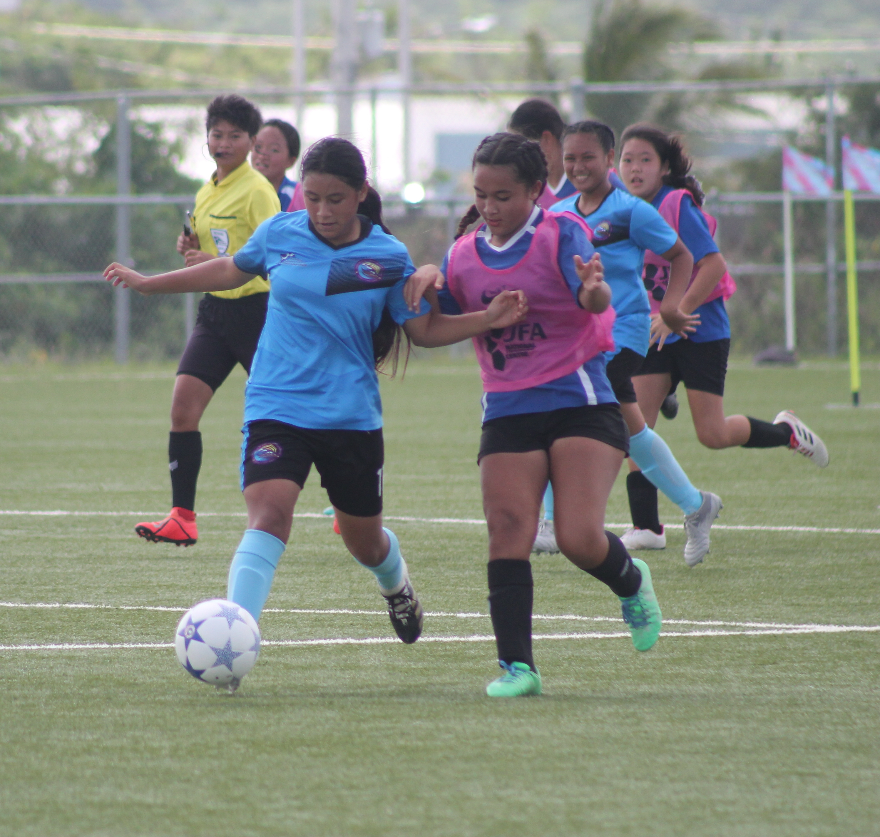 FMS' Rosie Saralu battles for the possession against SIS' Phoenix Gross during the championship of the NMIFA-PSS Interscholastic Girls Middle School Soccer League Saturday at the NMI Soccer Training Center.