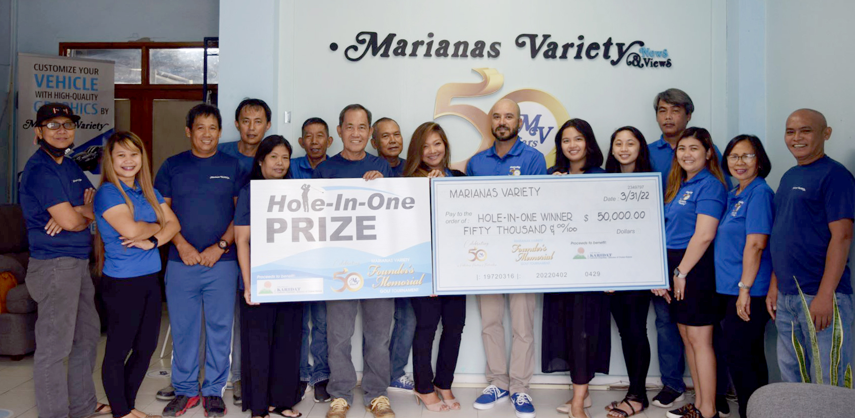 Marianas Variety President Amier Younis, center, poses with MV staff as they present a $50,000 hole-in-one prize for the MV Founder's Memorial Golf Tournament  set for Saturday, April 2 at 6 a.m., LaoLao Bay Golf & Resort, West Course. The event aims to raise funds for the charitable organization Karidat.