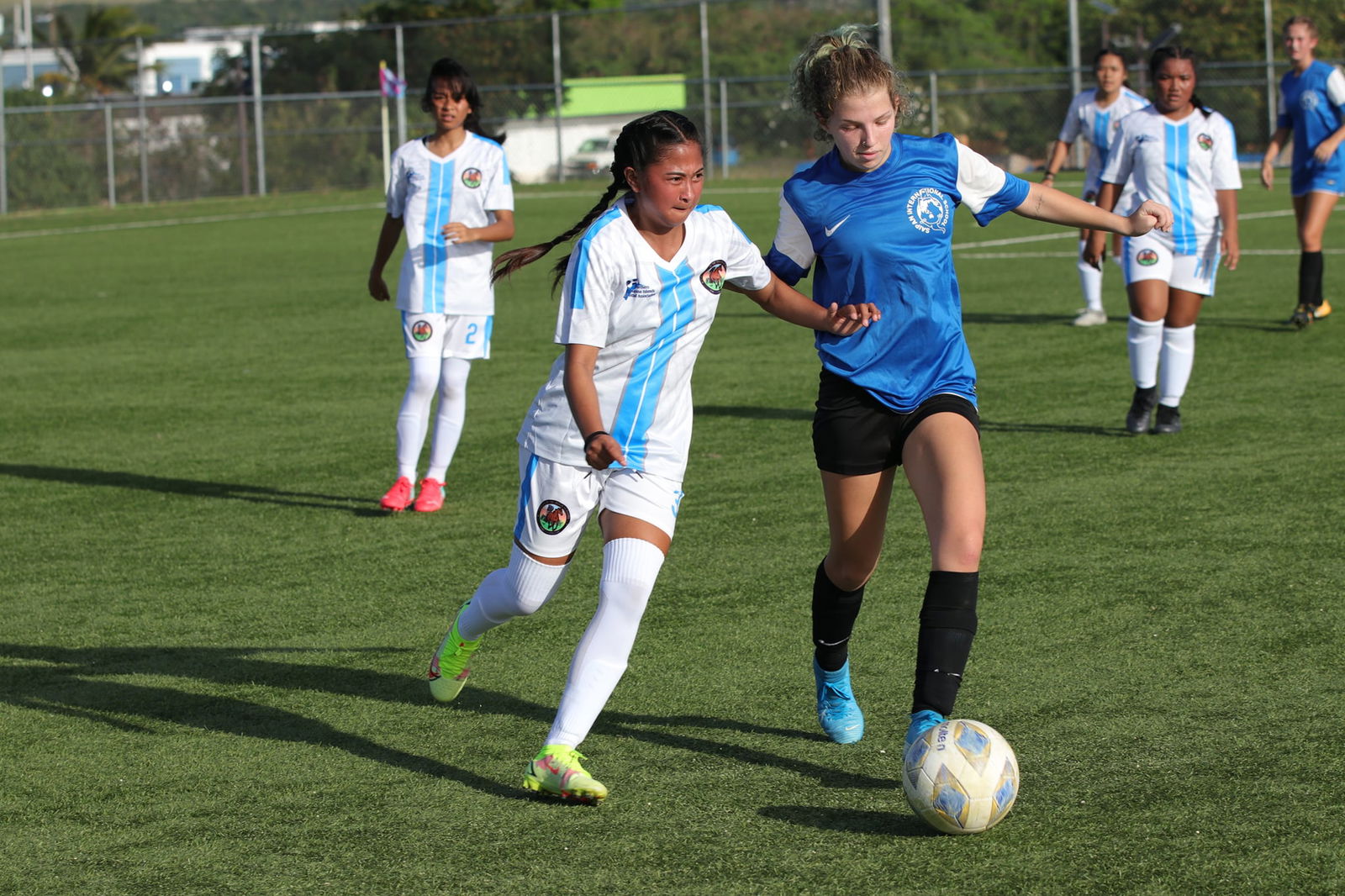 Saipan International School’s Piper Clark beats a defender for the possession during a  girl's high school division game of the NMIFA-PSS Interscholastic Soccer League at the NMI Soccer Training Center.