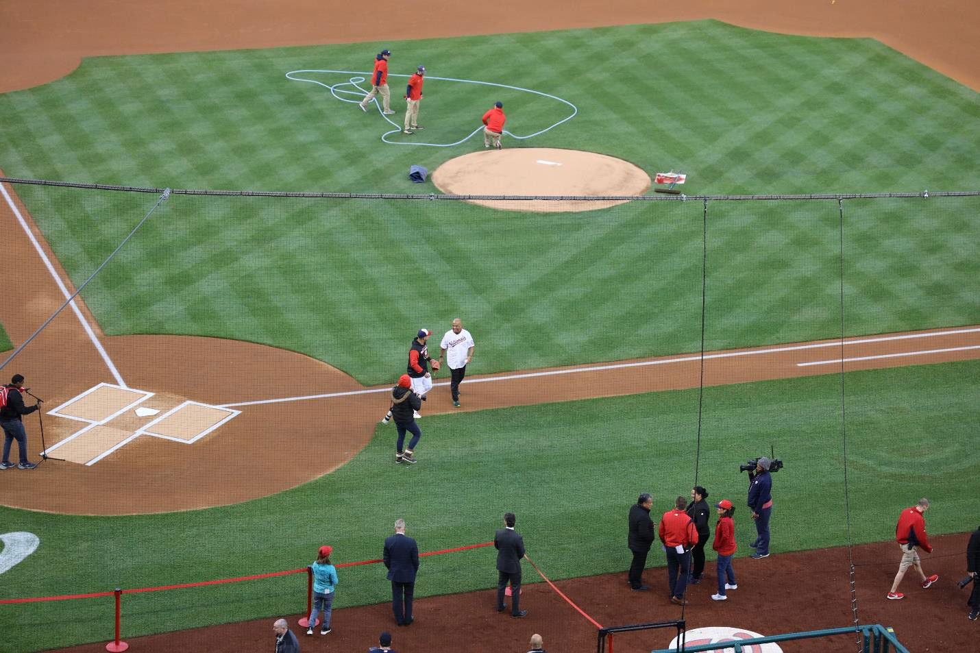 After throwing the first pitch, FSM President Panuelo returns to the seats to watch the game.