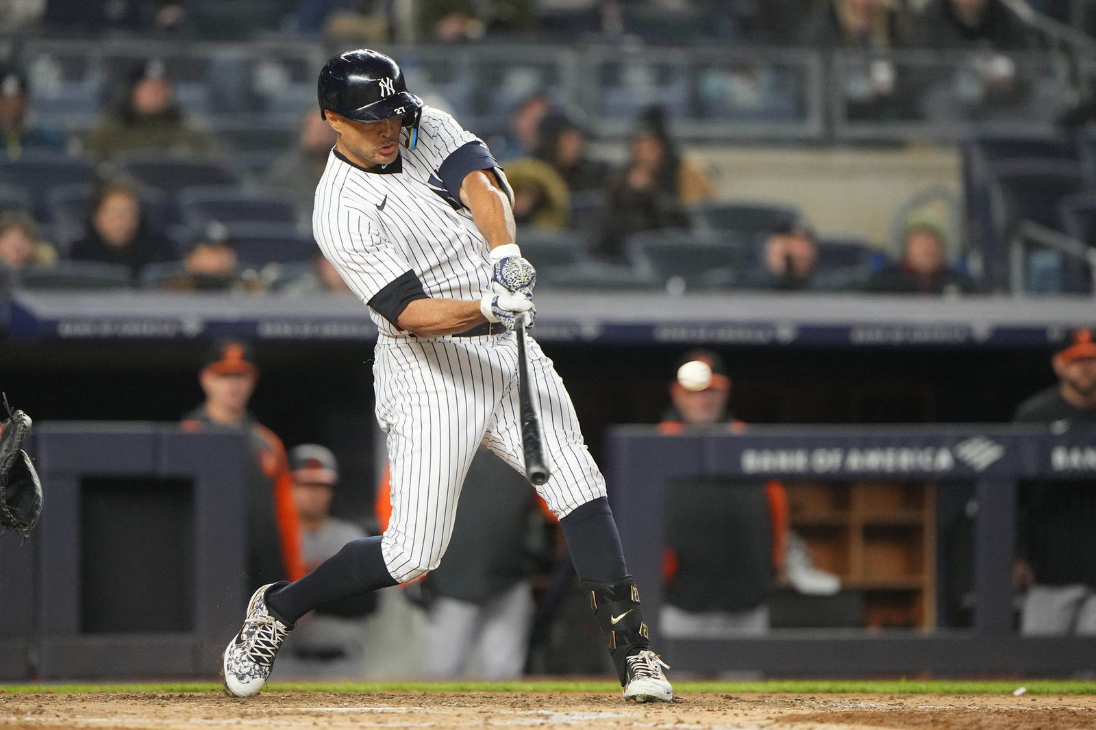 New York Yankees right fielder Giancarlo Stanton (27) hits a sacrifice fly ball during the sixth inning against the Baltimore Orioles at Yankee Stadium in the Bronx, New York on April 27, 2022.